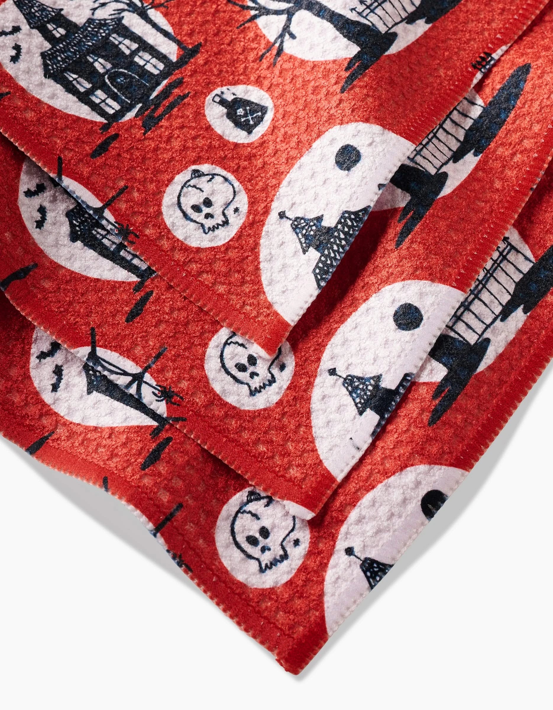 The Kayla Ann Haunted House red and white dishcloth set is crafted from absorbent Geoweave fabric with Halloween prints—haunted houses, bats, and cats on black circles—made from recycled materials for textured, eco-friendly style.