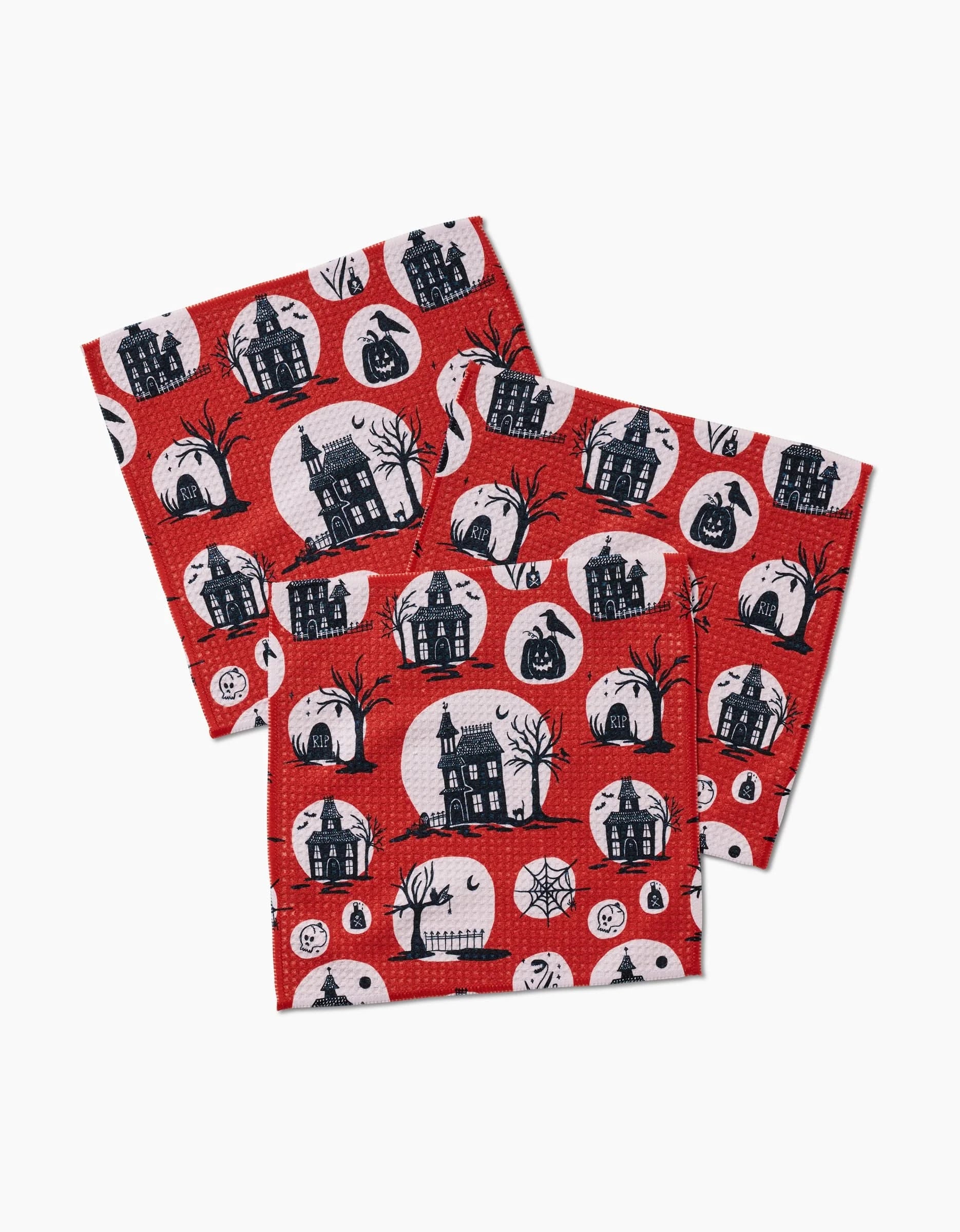 Set of three red Haunted House napkins by Kayla Ann, made from recycled materials, with black and white circles featuring haunted houses, bats, pumpkins, trees, fences & spider webs.