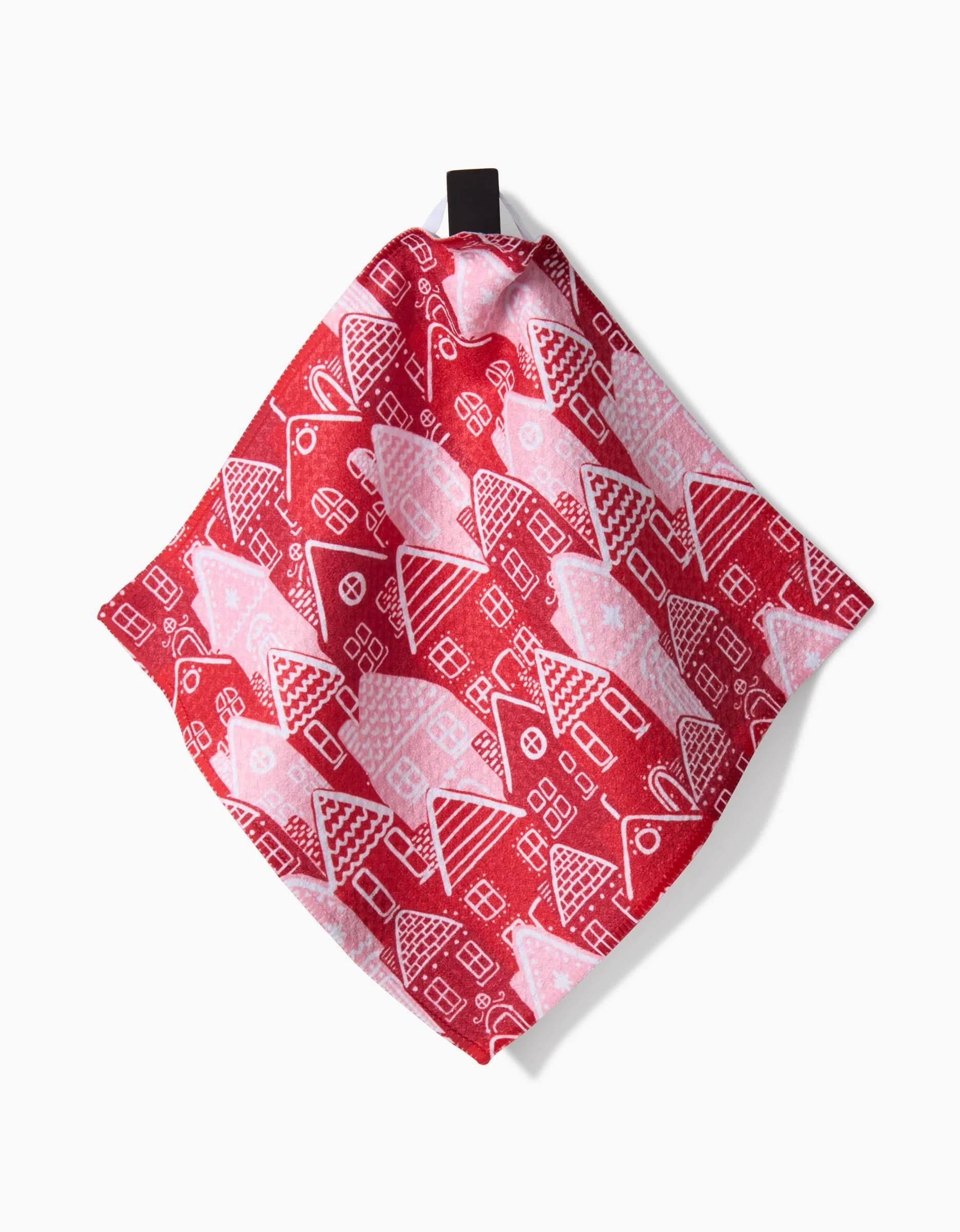 The Holidays kitchen towel by Hufton Studio features a red design with white and pink houses, various roofs and windows, super-absorbent Geoweave fabric, a black hanging loop, and a plain white background.