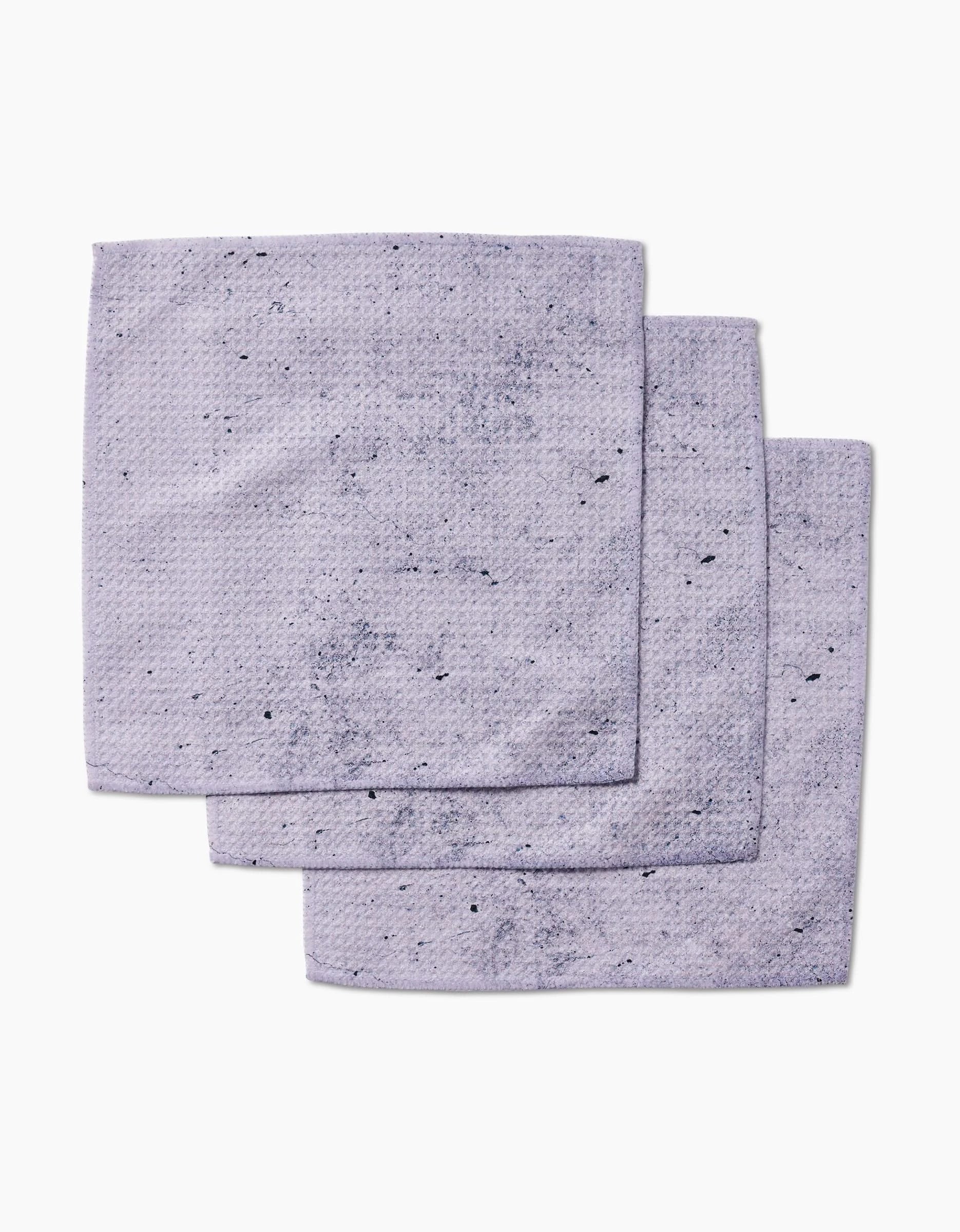 Three stacked Hudson Grey dishcloths from Kailee Wright, made of Geoweave fabric with a textured surface and scattered dark specks, arranged against a white background.