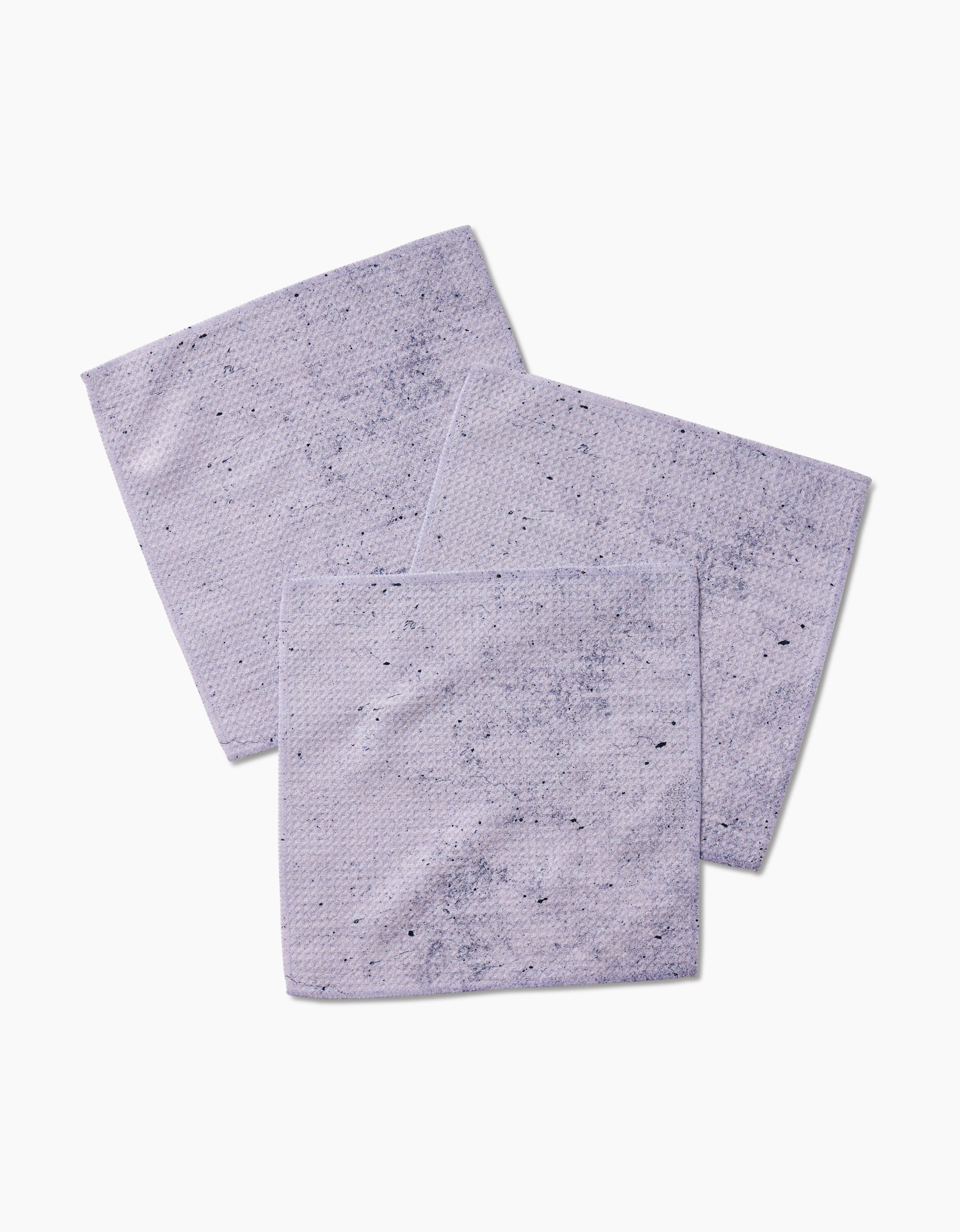 Three Hudson Grey dishcloths by Kailee Wright, featuring a textured Geoweave fabric and subtle darker speckles, are arranged overlapping on a white background.