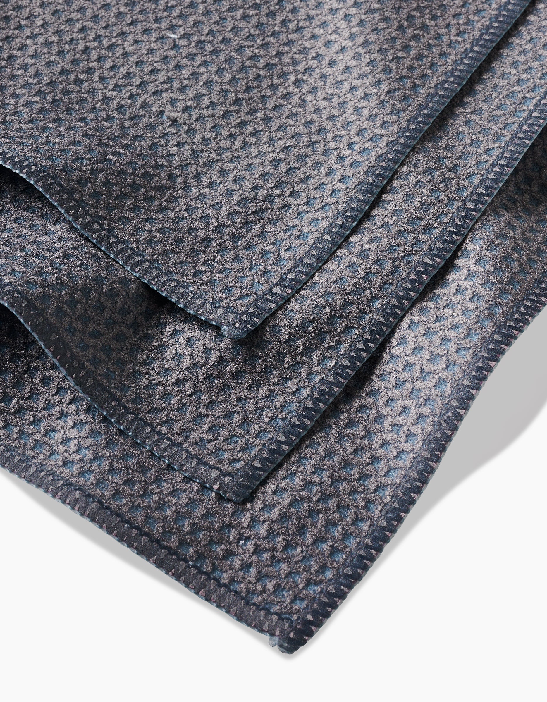 A close-up of the Hunter Green blanket by Kailee Wright, featuring a folded, textured surface with a subtle checkered pattern, made from super-absorbent Geoweave fabric and finished with neat edges.