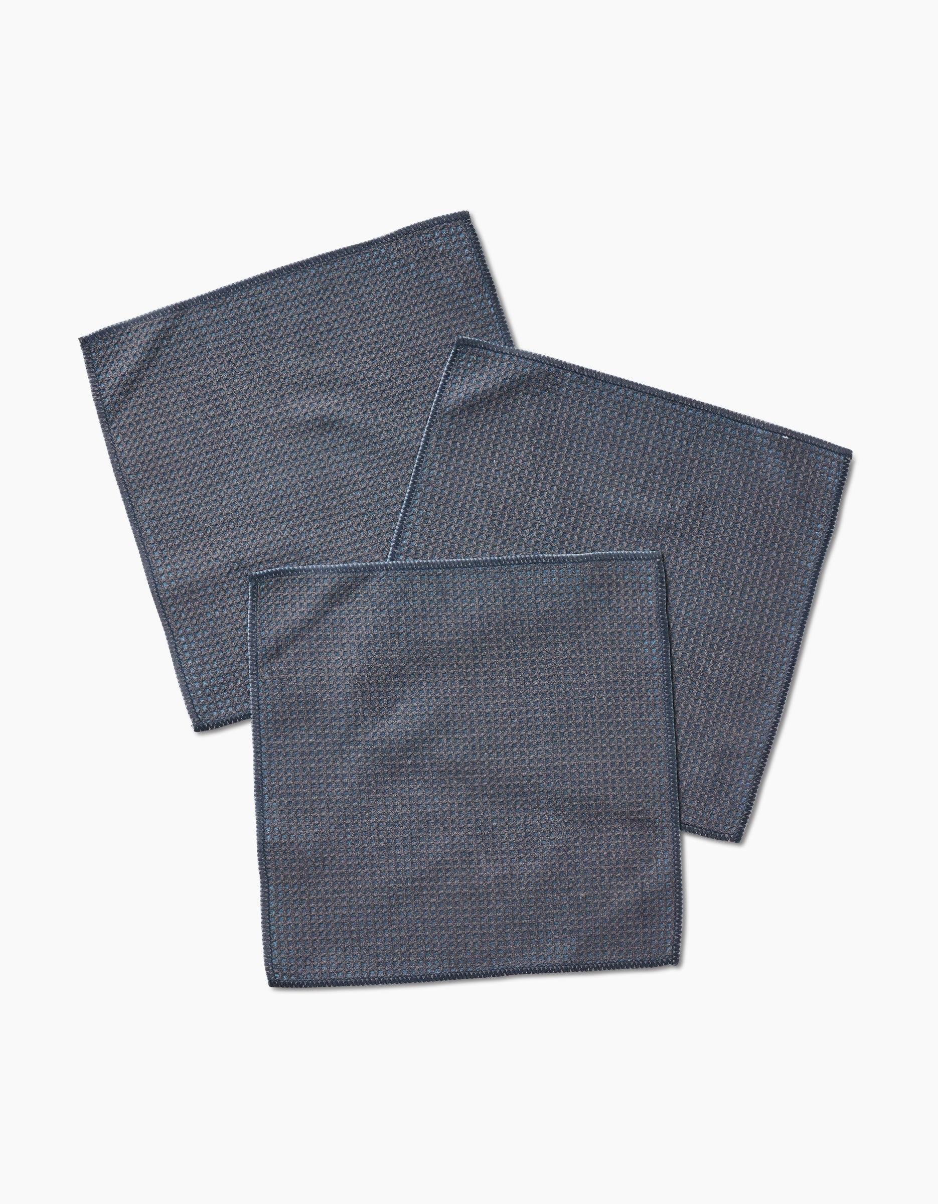 Three Hunter Green cloth napkins by Kailee Wright, made from super-absorbent Geoweave fabric, are neatly arranged in an overlapping pattern on a plain white background.