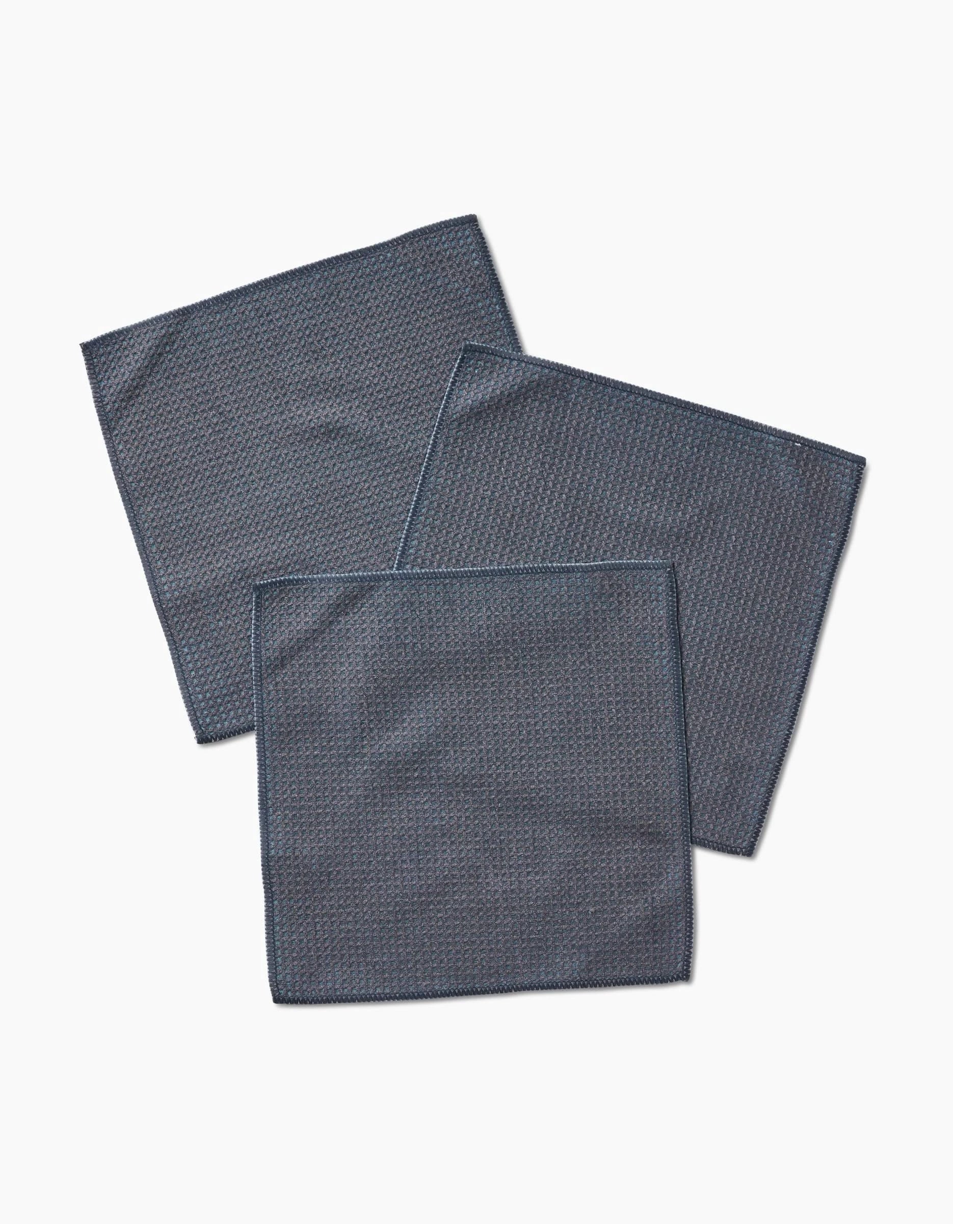 Three Hunter Green cloth napkins by Kailee Wright, made from super-absorbent Geoweave fabric, are neatly arranged in an overlapping pattern on a plain white background.