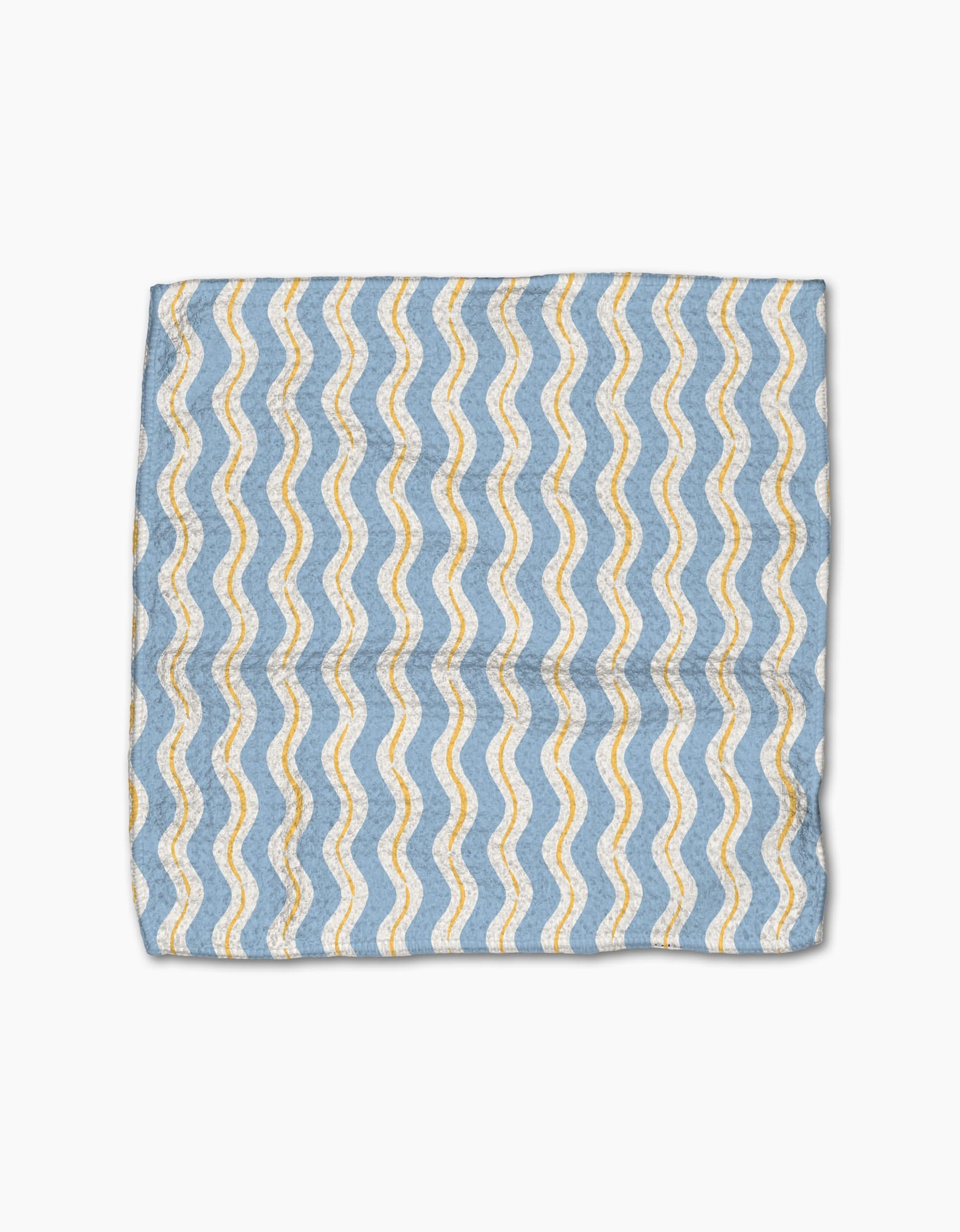 The Hufton Studio Lemon Waves dishcloth features a yellow and white wavy pattern on light blue Geoweave fabric, folded and displayed against a white background.