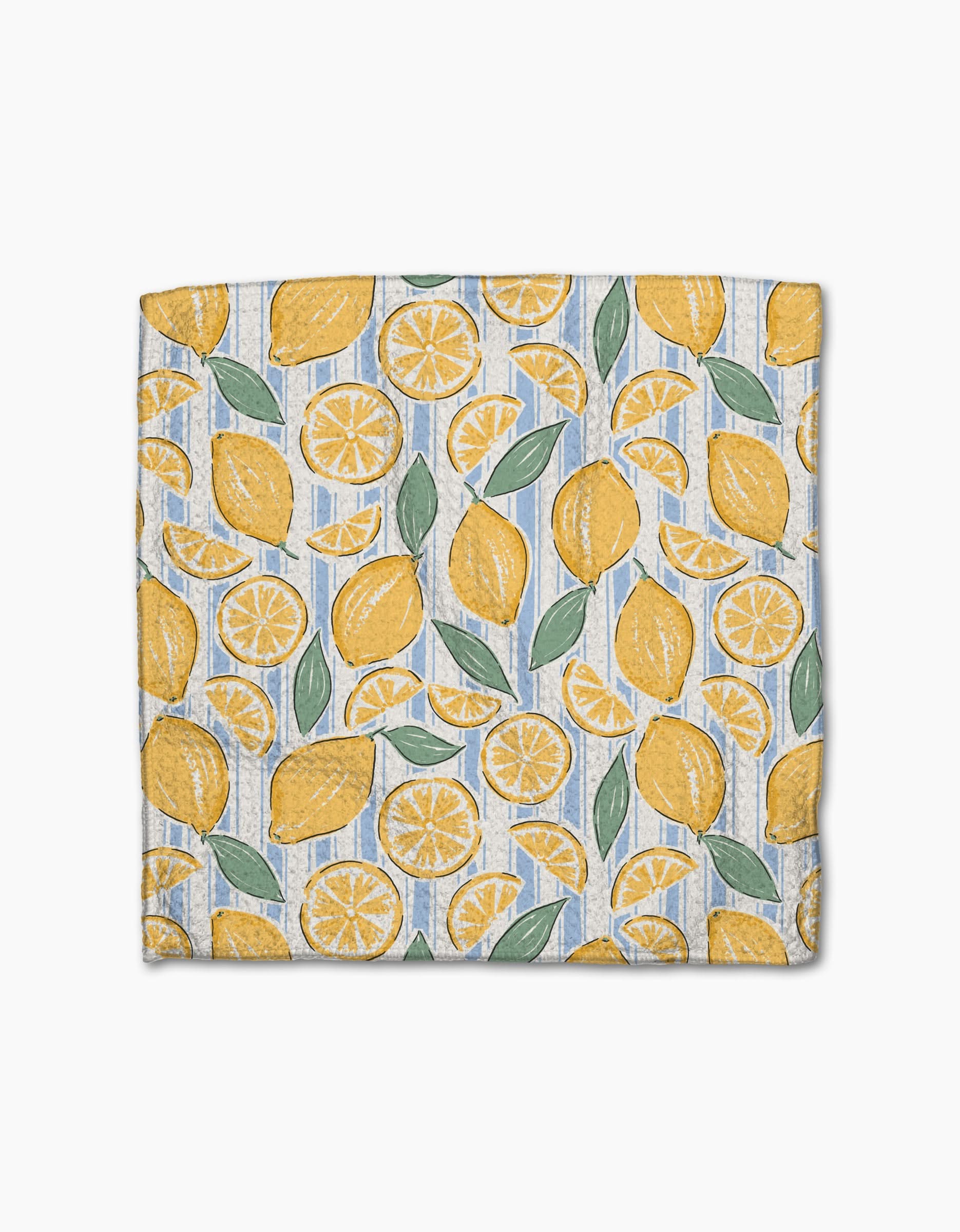 The Lemon Waves napkin by Hufton Studio showcases whole lemons, lemon slices, and green leaves on light blue and white stripes, made from super-absorbent Geoweave fabric for style and function.