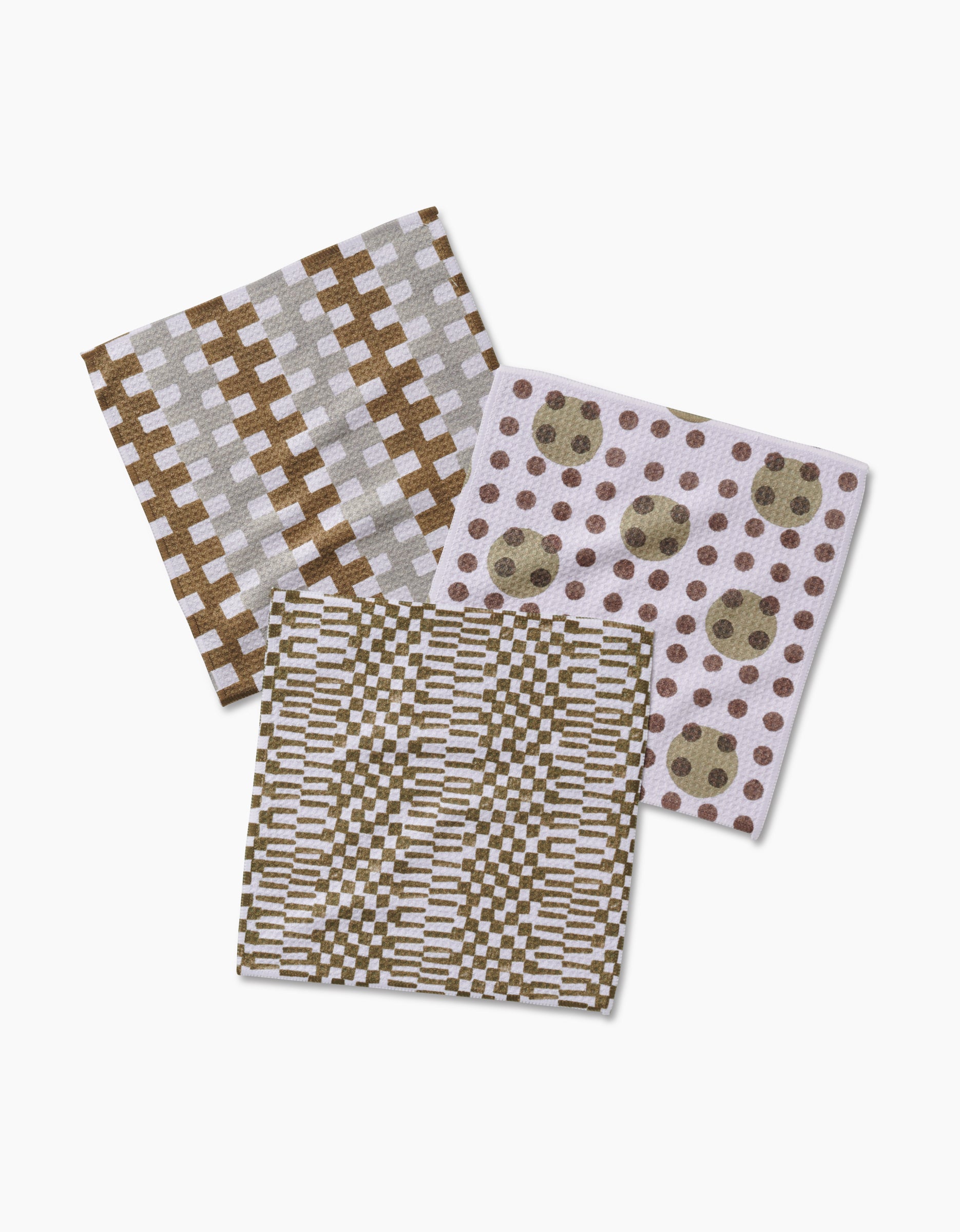 Lotty by Studio Jeannot: Three recycled geoweave square dishcloths in beige and brown, each with a distinct geometric or circular pattern, are shown overlapping on a white background.