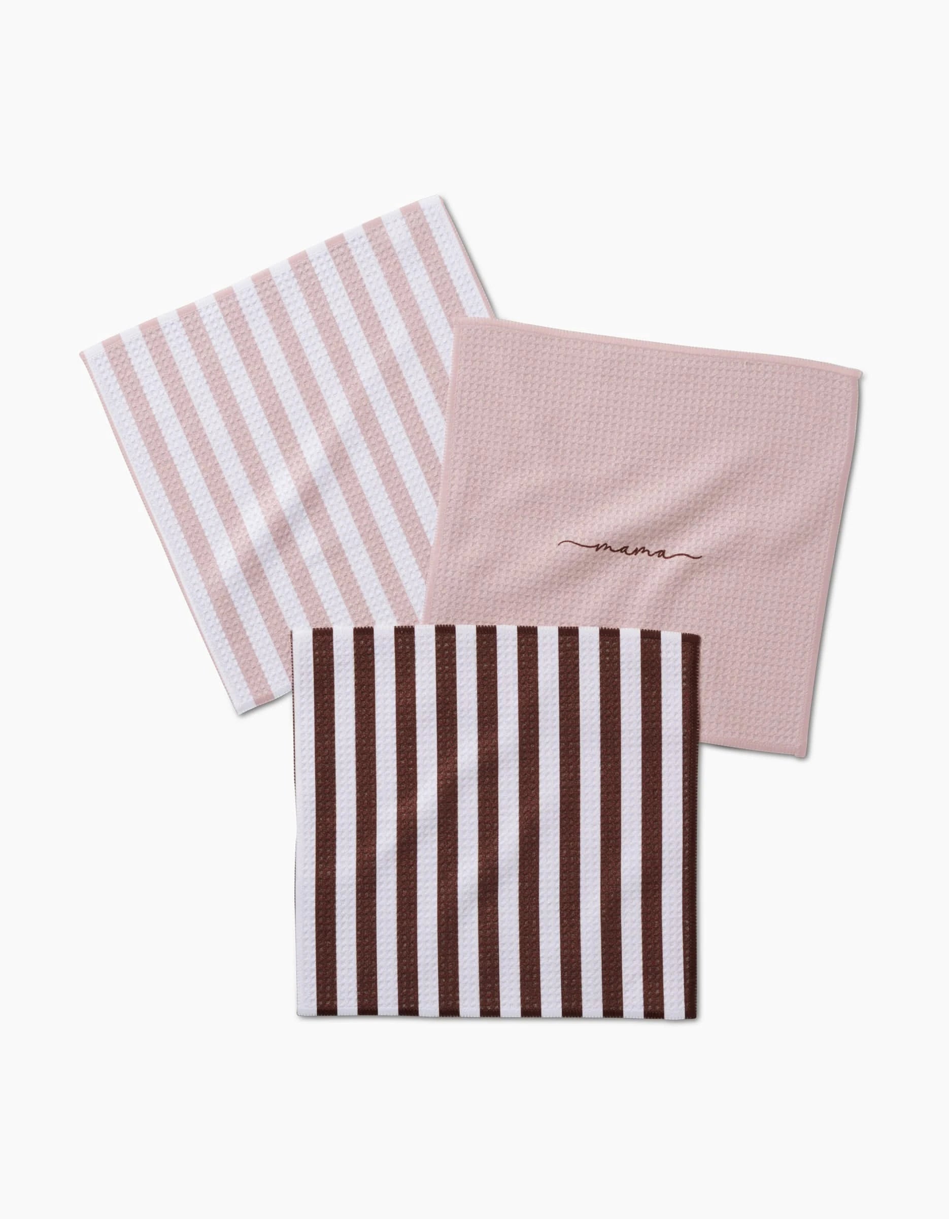 Three folded cloth napkins from Kailee Wrights Mama set: one pink with thin white stripes, one solid pale pink embroidered “mama,” and one brown with thick white stripes—made from recycled materials and shown on a white background.