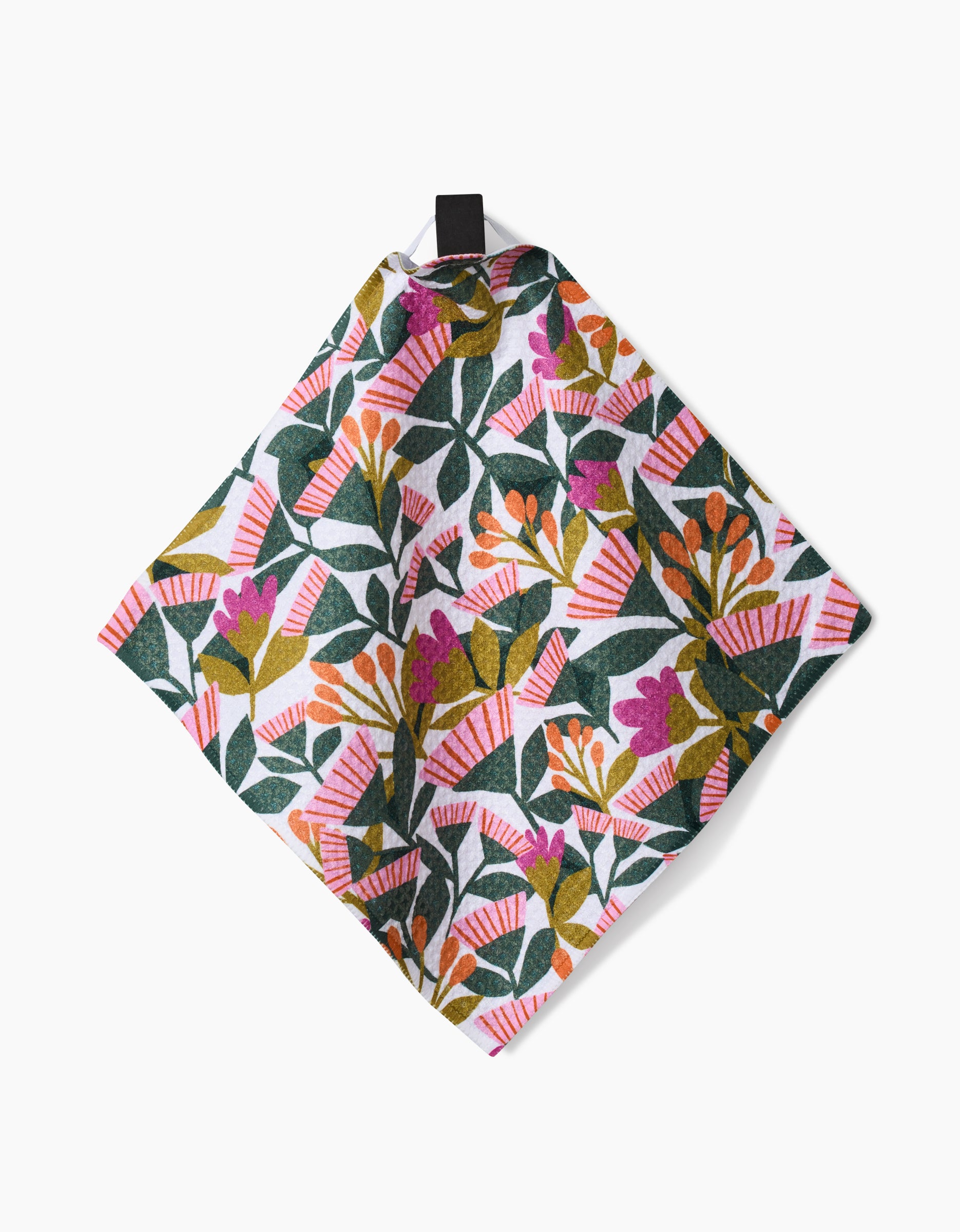 Moxie Mauve by Lisa Nelson: a square cloth napkin made from recycled materials, showcasing a vibrant floral and leaf pattern in pink, green, orange, and purple with a black hanging loop, displayed on a white background.
