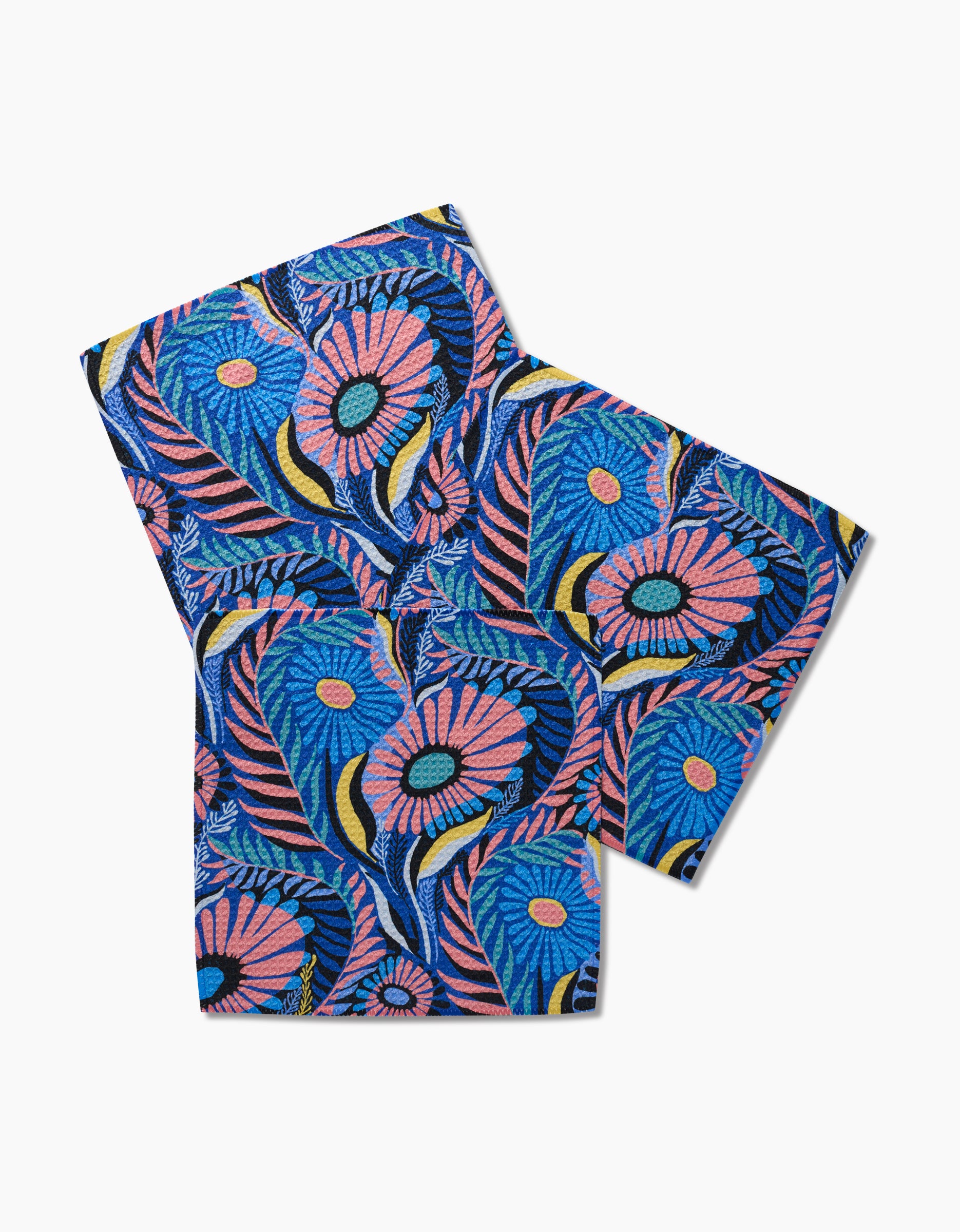 Two folded Palm Beach dishcloths by Masha Volnova feature a vibrant blue, pink, yellow, and black floral pattern on white Geoweave fabric with bold flowers and abstract leaves. Crafted from eco-friendly materials.