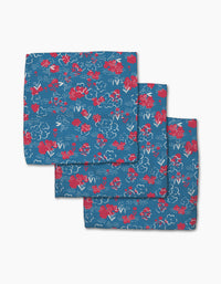 The Patriotic Garden Dishcloth Set from Second Nature Studio features three blue napkins with a red and white floral pattern, made from recycled materials for eco-friendly charm against a plain white background.