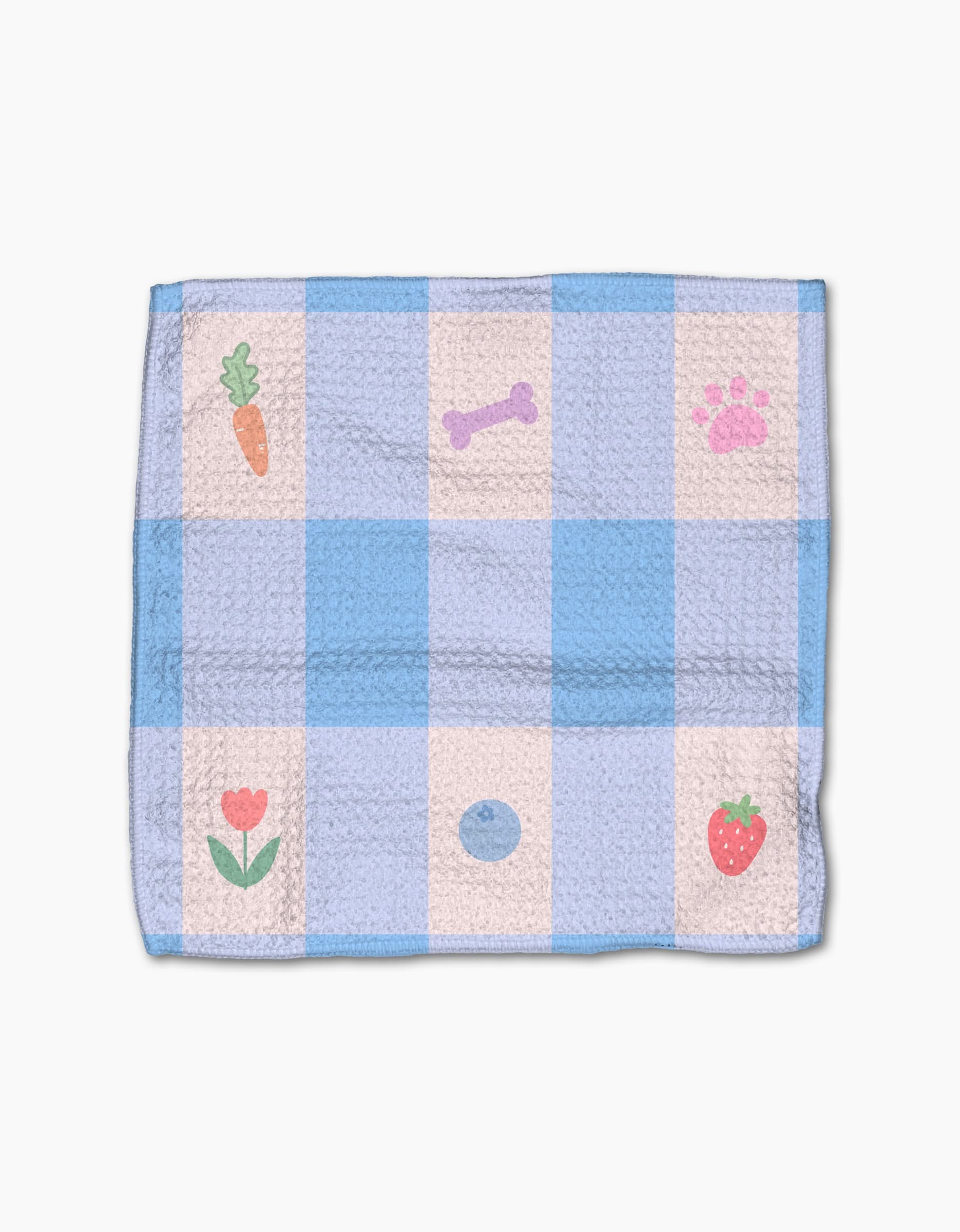 The Pawfect Picnic dishcloth set by Letters By Shells features blue and white checks with small carrot, bone, paw print, flower, blueberry, and strawberry illustrations. Made from recycled materials; shown on a plain white background.