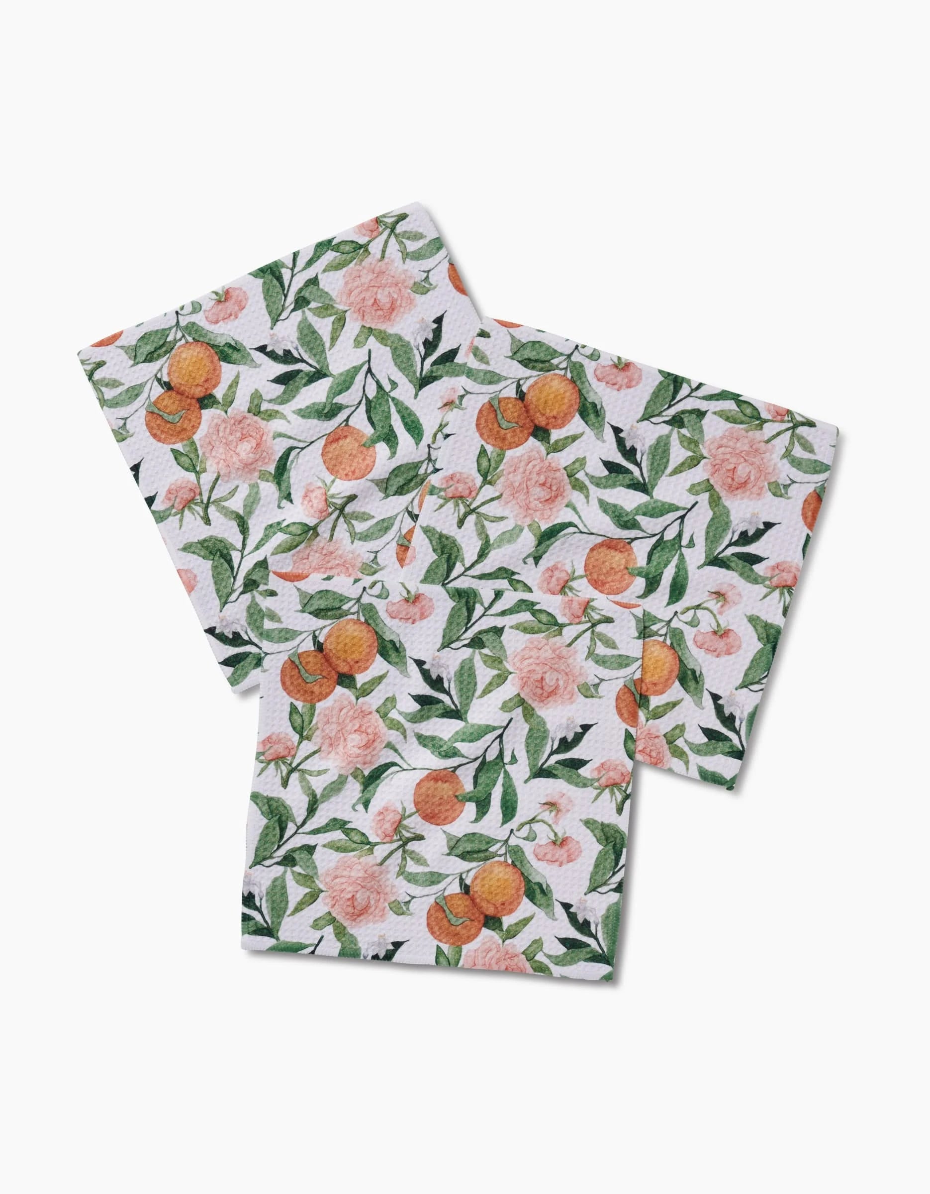 Three eco-friendly Peony For Your Thoughts paper napkins by Aubrey Fairchild, featuring peach and pink floral patterns with green leaves, are perfect for pairing with a recycled-material Dishcloth Set.