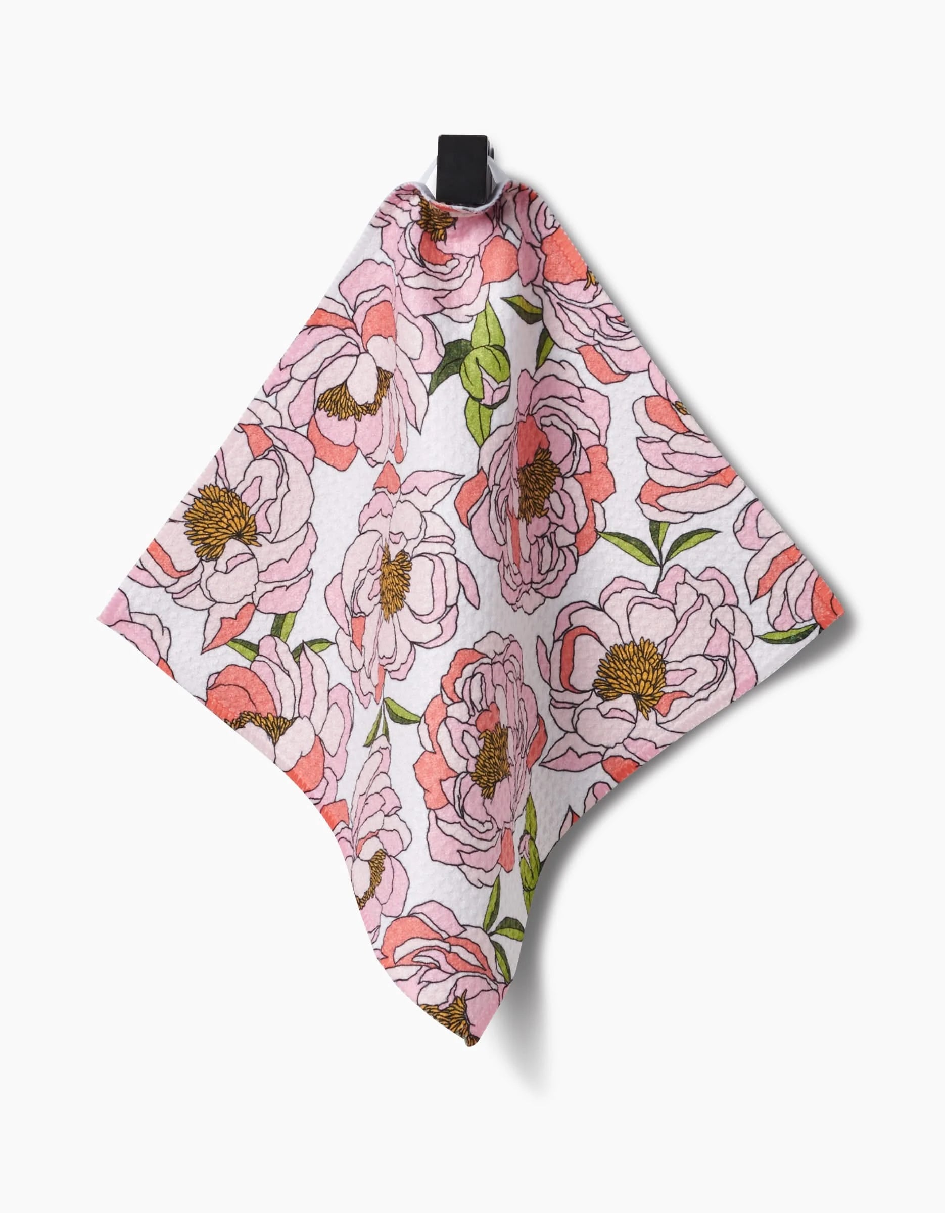 Shelley Smiths Peony Paradise dishcloth, crafted from Geoweave fabric and designed with a pink and white floral pattern of blooming flowers and green leaves, hangs from a black loop against a white background.