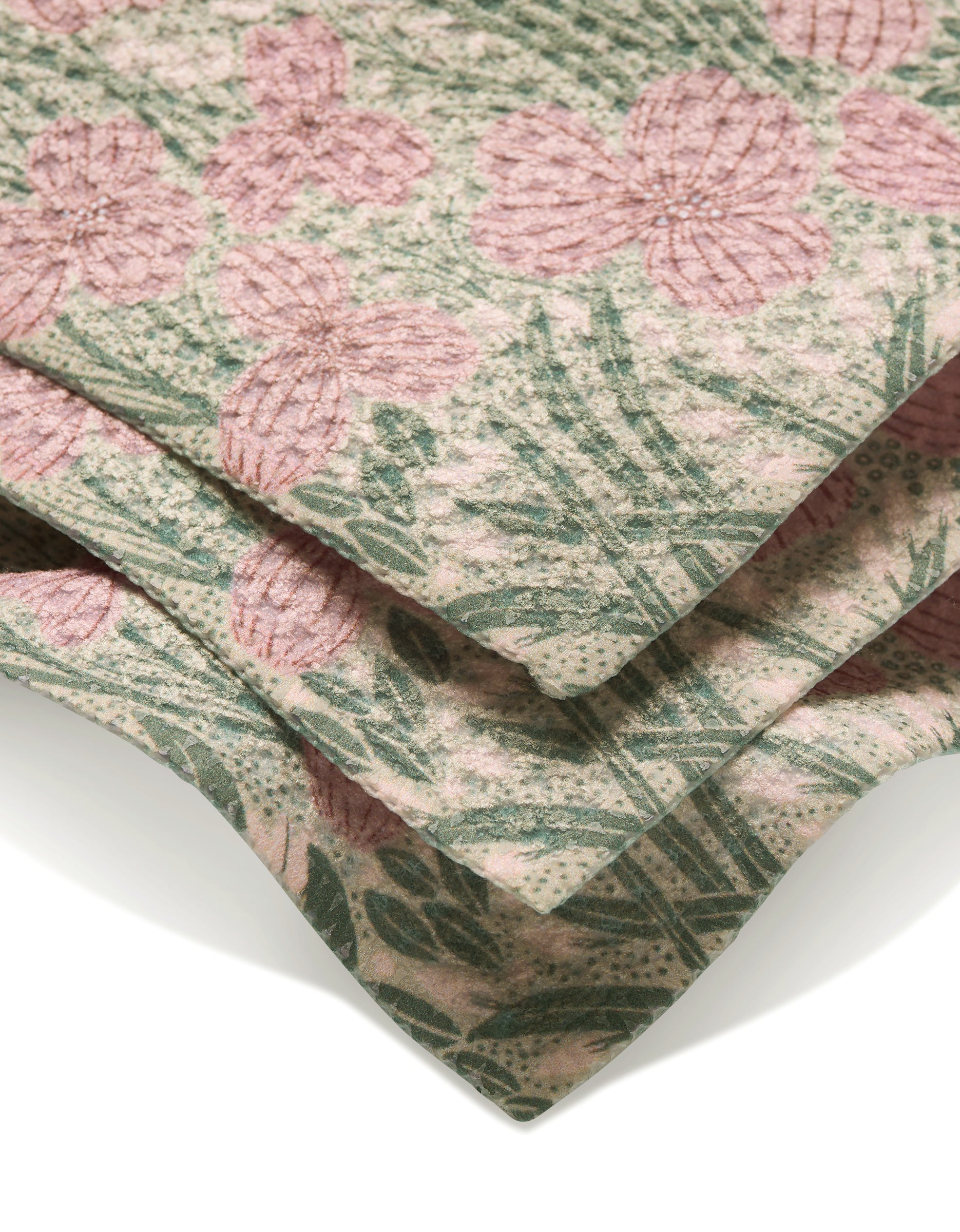 Close-up of the Katie OShea Pink and Sage Meadow dishcloth, crafted from Geoweave fabric with a soft, textured feel. Features a pink floral and green leaf pattern on a light background.