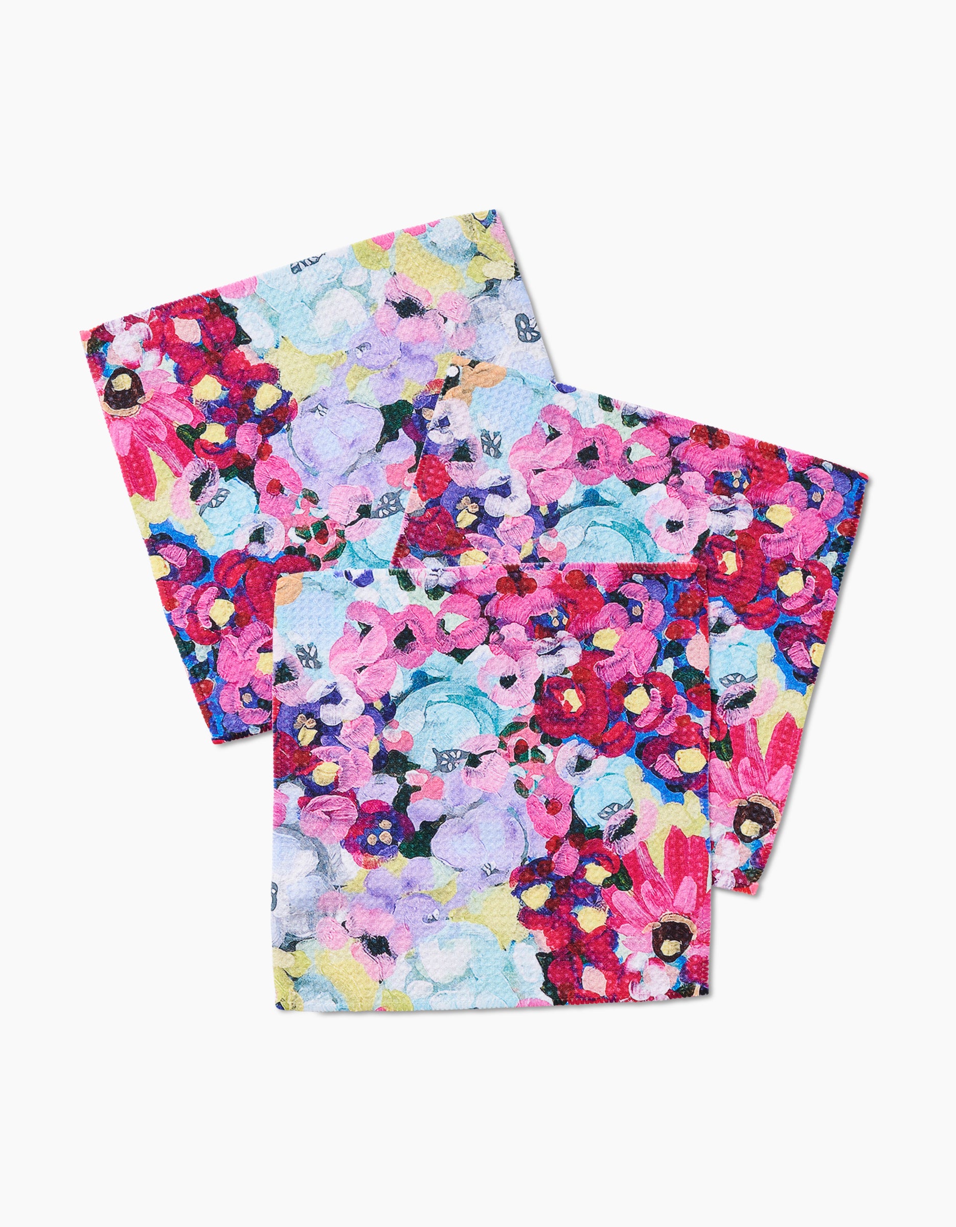 The Pink Fields of Joy napkins by Ania Zwara Art are two square cloth napkins made from Geoweave fabric, featuring a vibrant floral pattern in pink, purple, red, blue, and yellow—perfect for brightening any table.
