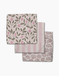 Three folded Pink Summer cloth napkins by Teri the Butter—one with pink and brown leaf and lemon print, one with pink and white stripes, and one with a pink seashell design—are arranged on a white background.