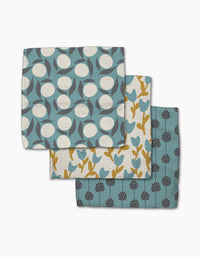 Polka Dot Blooms by Lizzie Clark includes three folded tea towels made from recycled materials, each featuring unique botanical patterns in blue, yellow, and white.