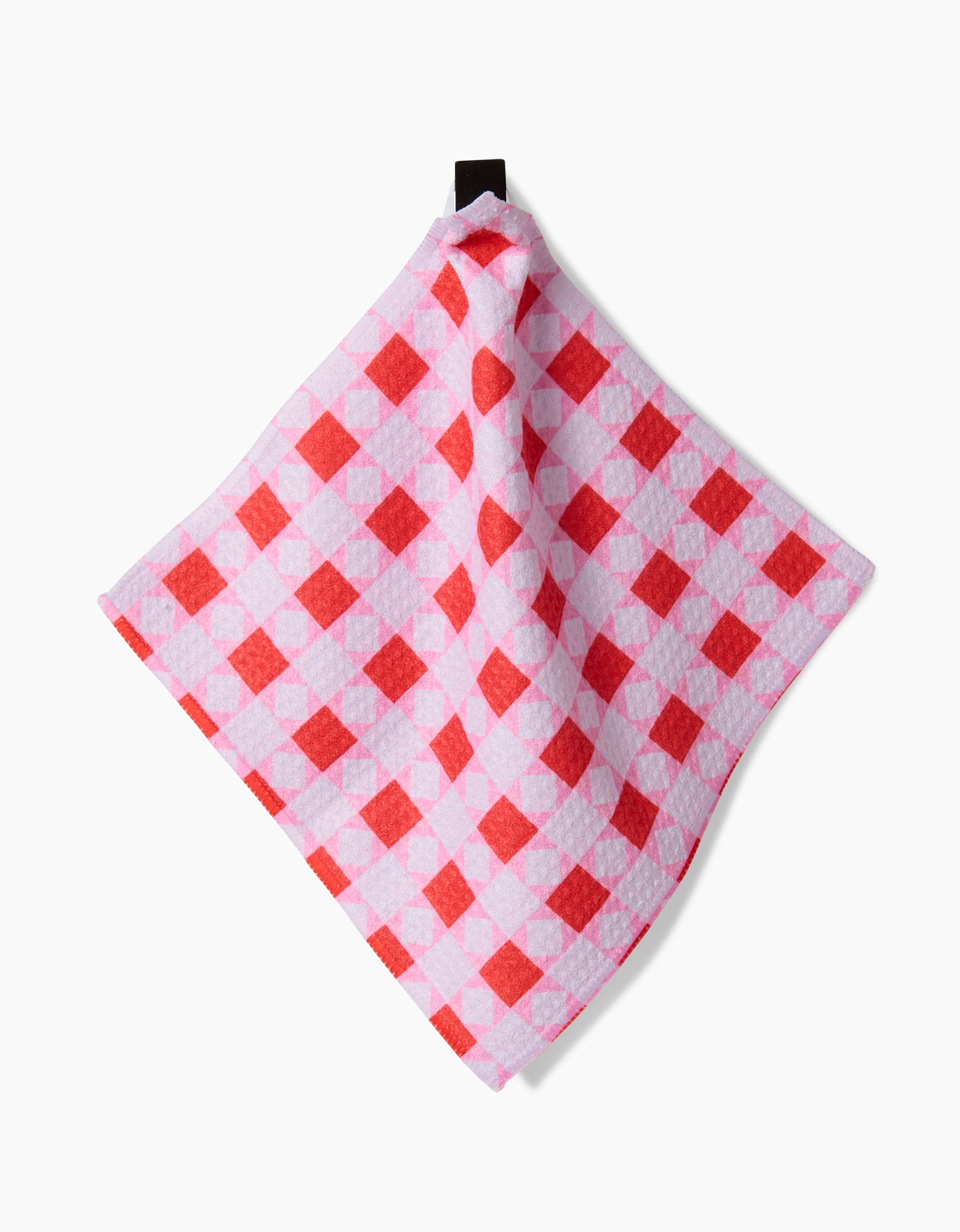 The Quilt Tomato Harvest dishcloth by Brittany Jepsen, made from Geoweave fabric in pink and red checks with a hanging loop, is shown against a white background.