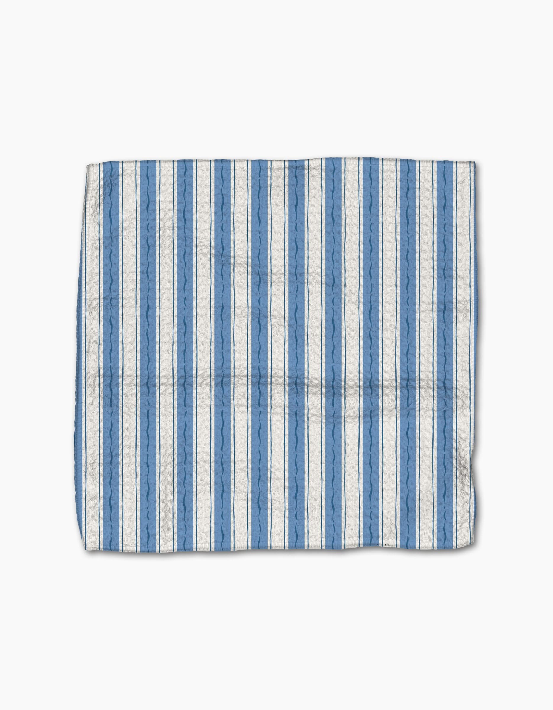 The Sardine Check Blue dishcloth by Hufton Studio features vertical blue and white stripes and a slightly wrinkled texture, crafted from Geoweave fabric. It is shown on a white background.