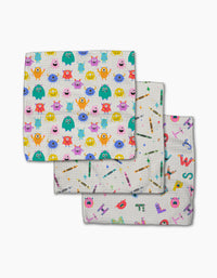 Scribble Squad by Vaishali Design Studio features three folded dishcloths in colorful cartoon monster, school supply, and letter/creature patterns—all made of soft, absorbent Geoweave fabric.