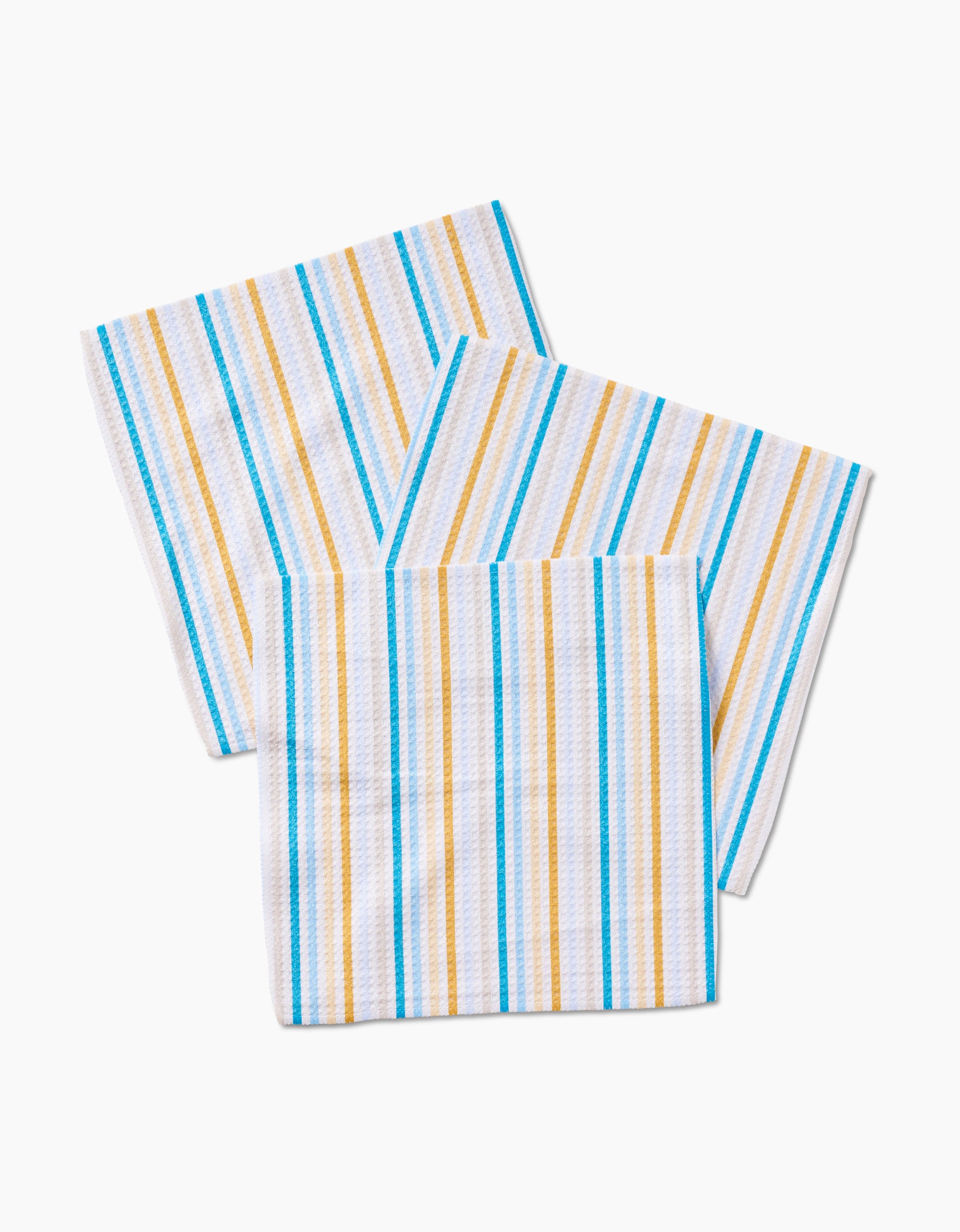 Three GEOMETRY Seaside Sunshine Geoweave fabric kitchen towels, featuring blue, yellow, and light brown vertical stripes on white, are laid out on a flat surface.