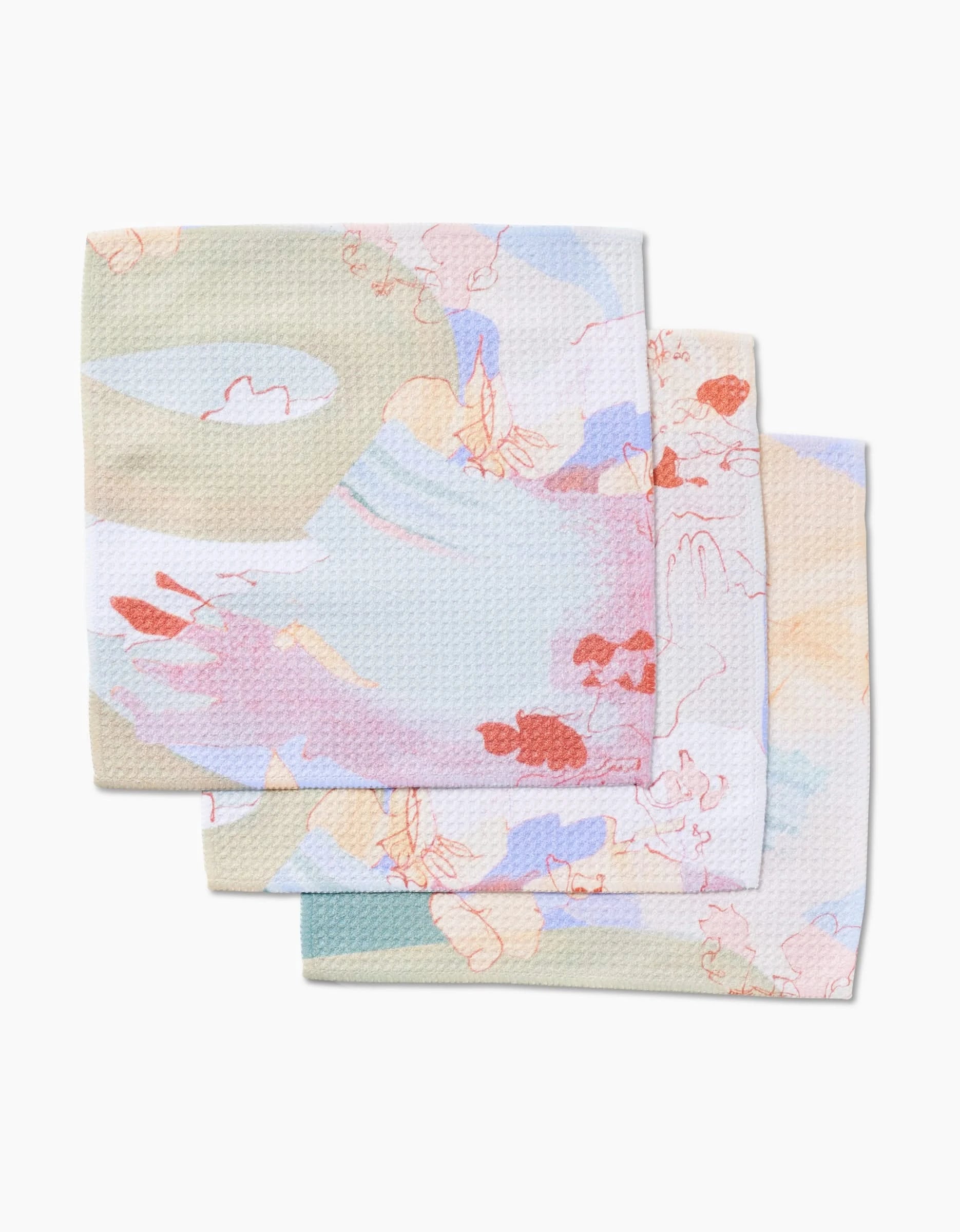 Three Kristina Baker Secret Fort reusable dishcloths, made from Geoweave fabric with a pastel abstract floral pattern in pink, beige, blue, and green, are stacked slightly overlapping on a white background.