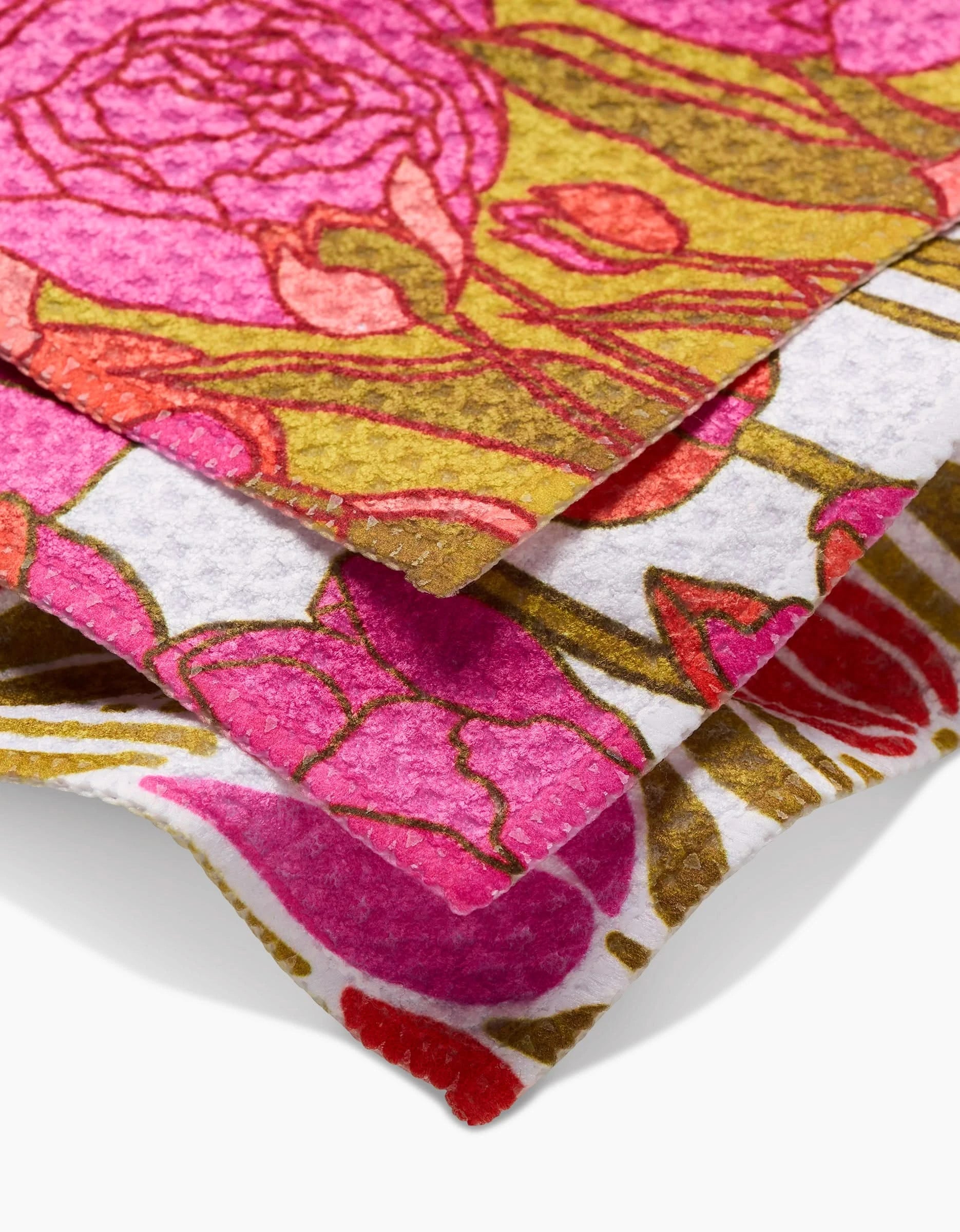 Three stacked Sidney dishcloths by Amy MacCready are crafted sustainably from recycled Geoweave fabric, featuring vibrant pink, red, green, and white floral patterns with intricate leaf and flower designs.