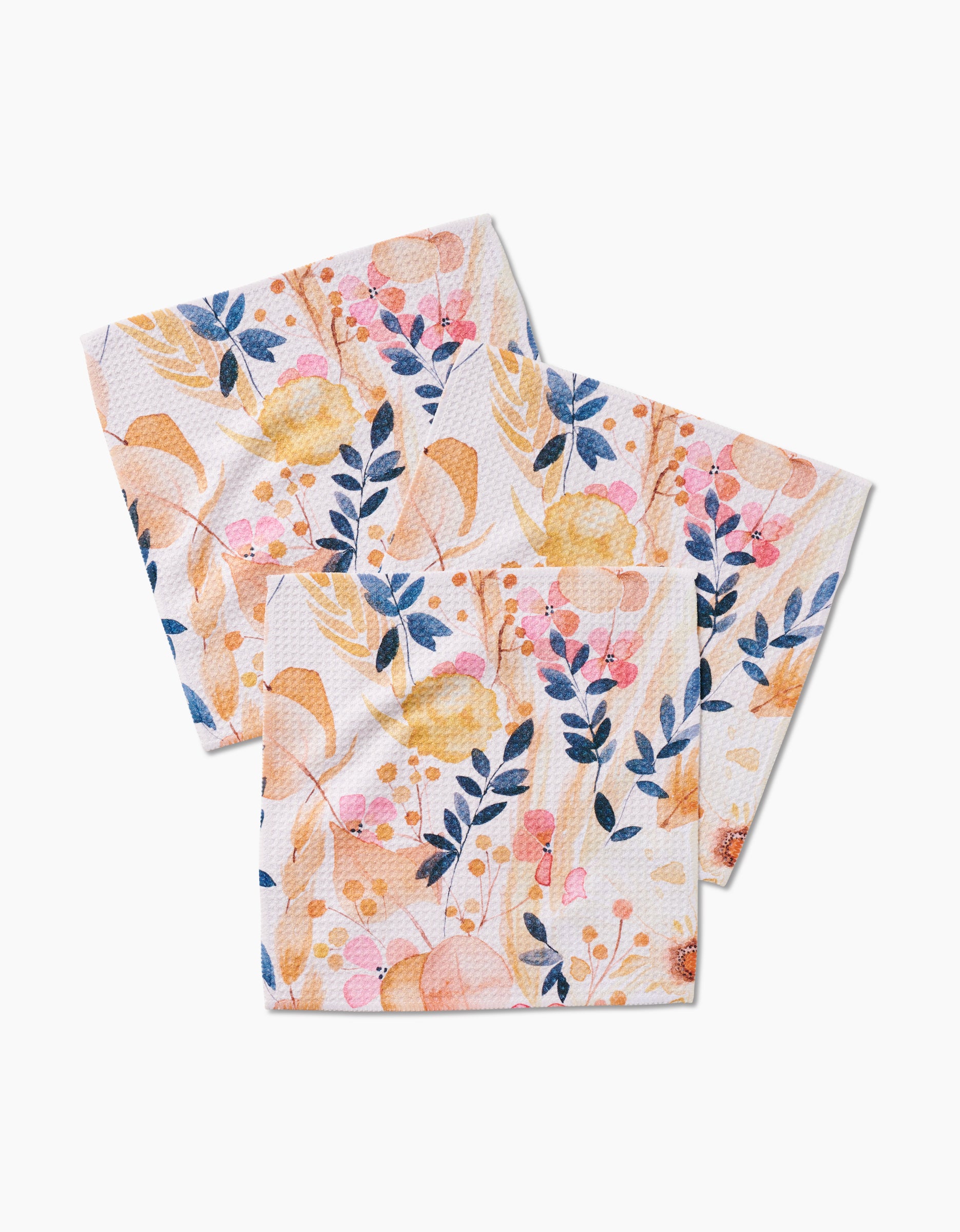 Three Sleepy Fields paper napkins by GEOMETRY, featuring a vibrant floral pattern in yellow, pink, and blue—arranged overlapping on white. Made from recycled materials for an eco-friendly touch.