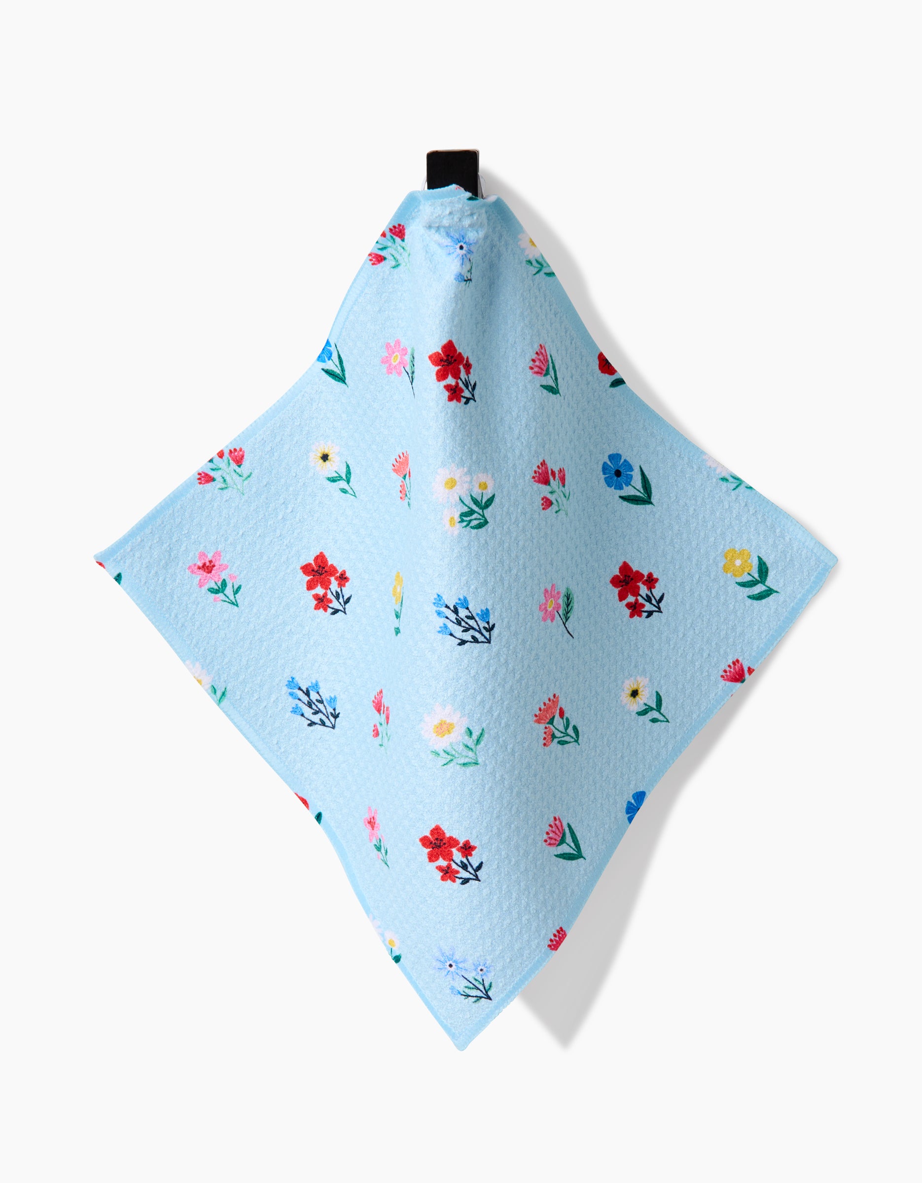 The Spring House Blossom by Ceyda Alasar is a light blue Geoweave dishcloth featuring colorful red, pink, yellow, and blue flowers with a black hanging loop—part of our super-absorbent Dishcloth Set.