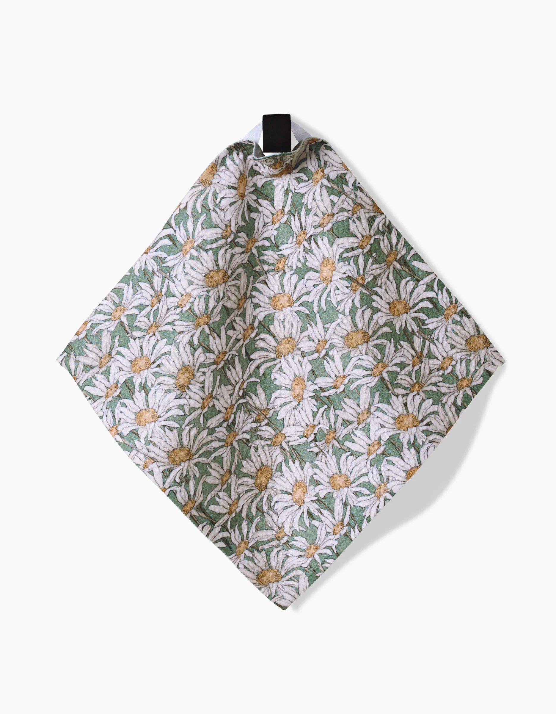 The Springtime cloth by Aubrey Fairchild, crafted from super-absorbent Geoweave fabric with white daisies and green leaves, hangs from a black loop against a plain white background.