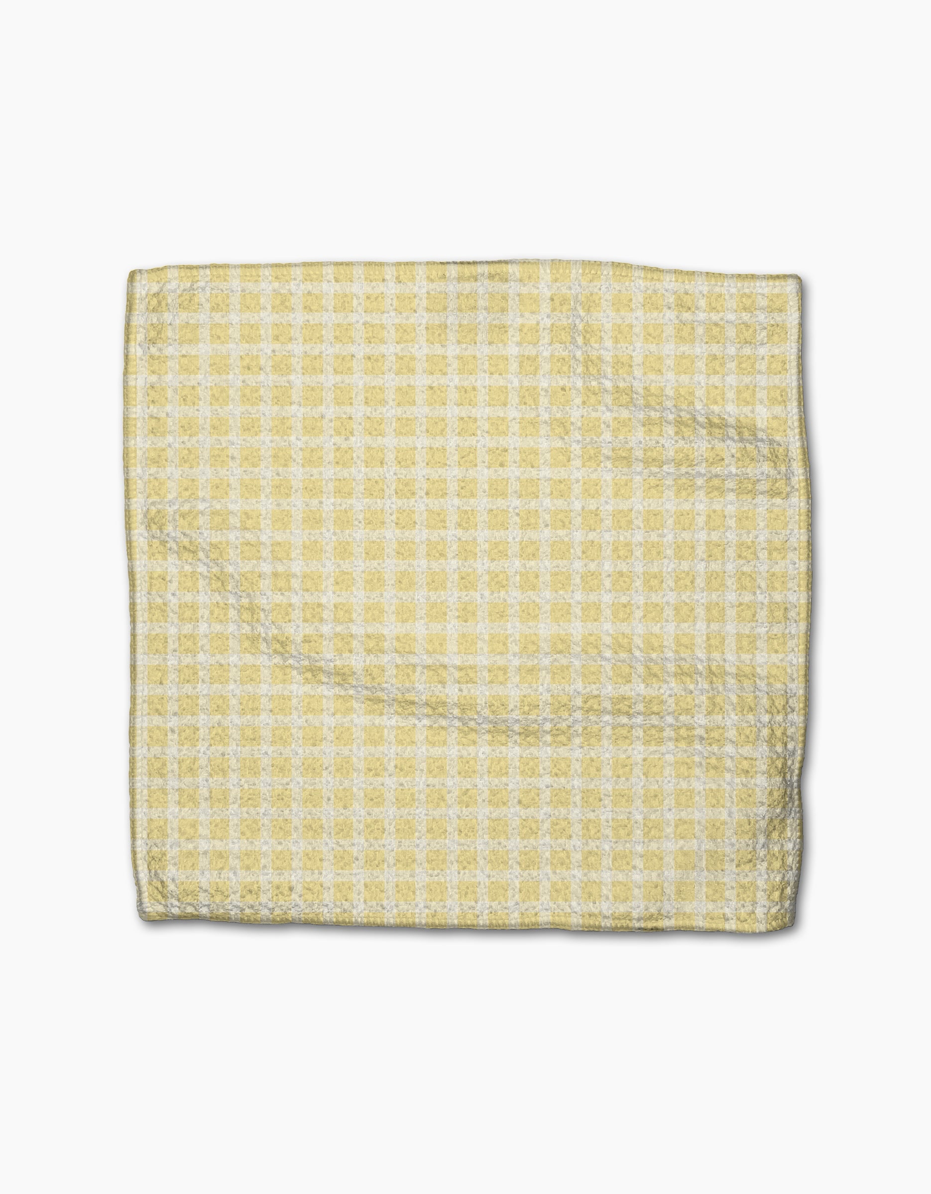 The GEOMETRY Sunspread napkin, featuring a yellow and white checkered design and made from recycled materials, is shown folded on a plain white background.