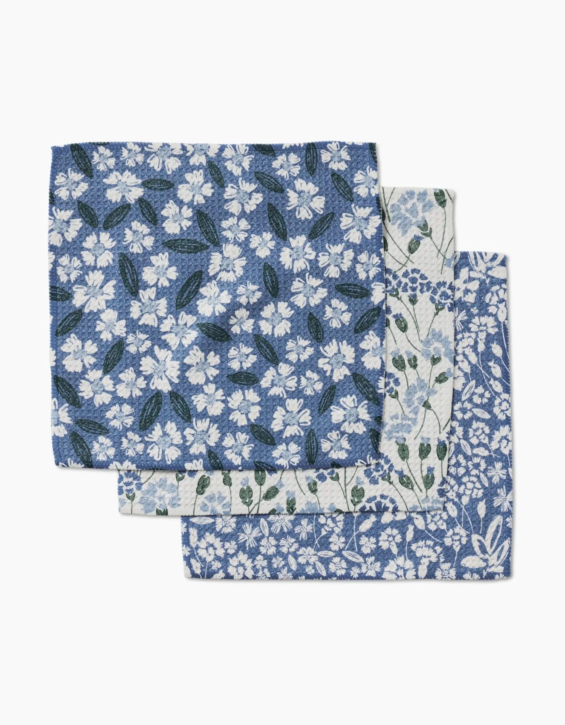 Three Sweetie Floral handkerchiefs by Hufton Studio, each with unique blue and white floral designs, stacked on a white background—eco-friendly and perfect as sustainable dishcloths for your home.