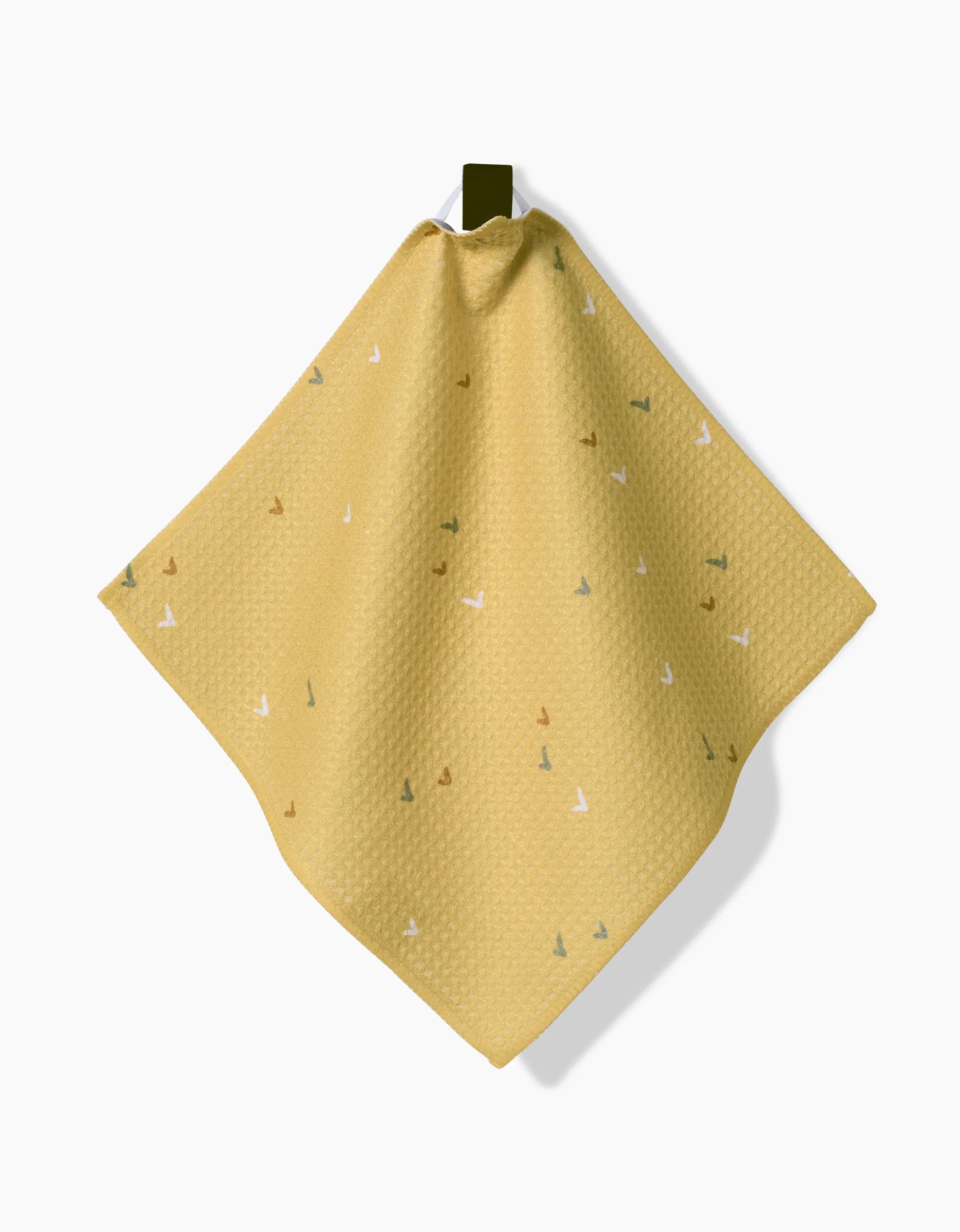 The Danelys Sidron Wildflowers dishcloth, made of yellow Geoweave fabric with small multicolored triangle patterns, hangs from a dark top loop against a white background.