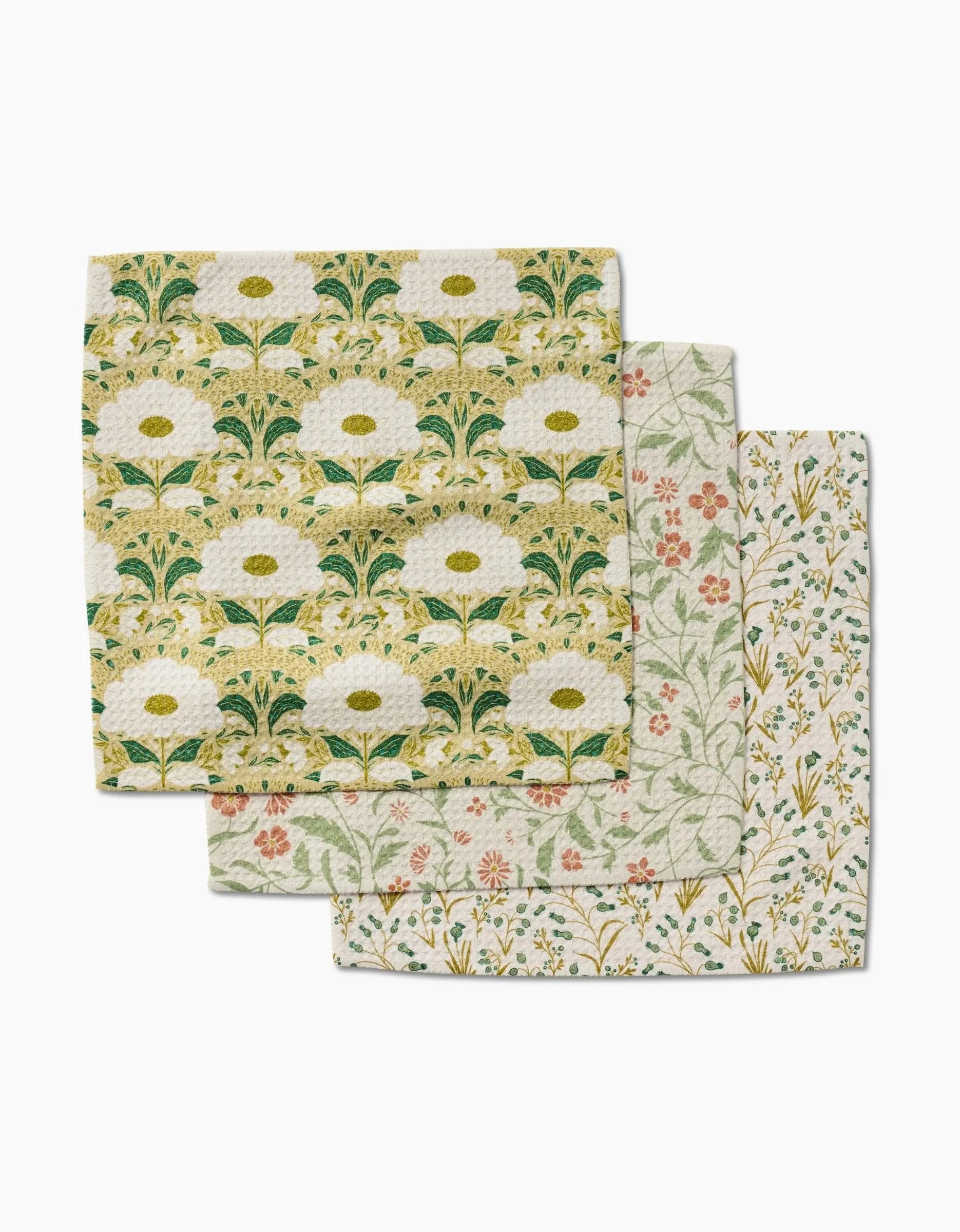 The Danelys Sidron Wildlight set features three patterned cloth napkins made from recycled materials, each with unique green, yellow, orange, and white floral designs; the top displays a bold yellow and green motif.
