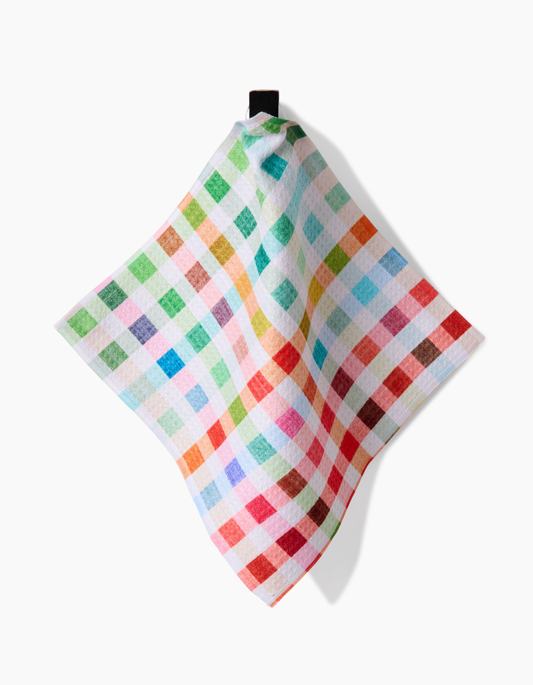 The Pascale Dilger Woven Spring Plaid tea towel features a colorful red, green, blue, and yellow checkered pattern in Geoweave fabric and hangs from a black loop against a white background.