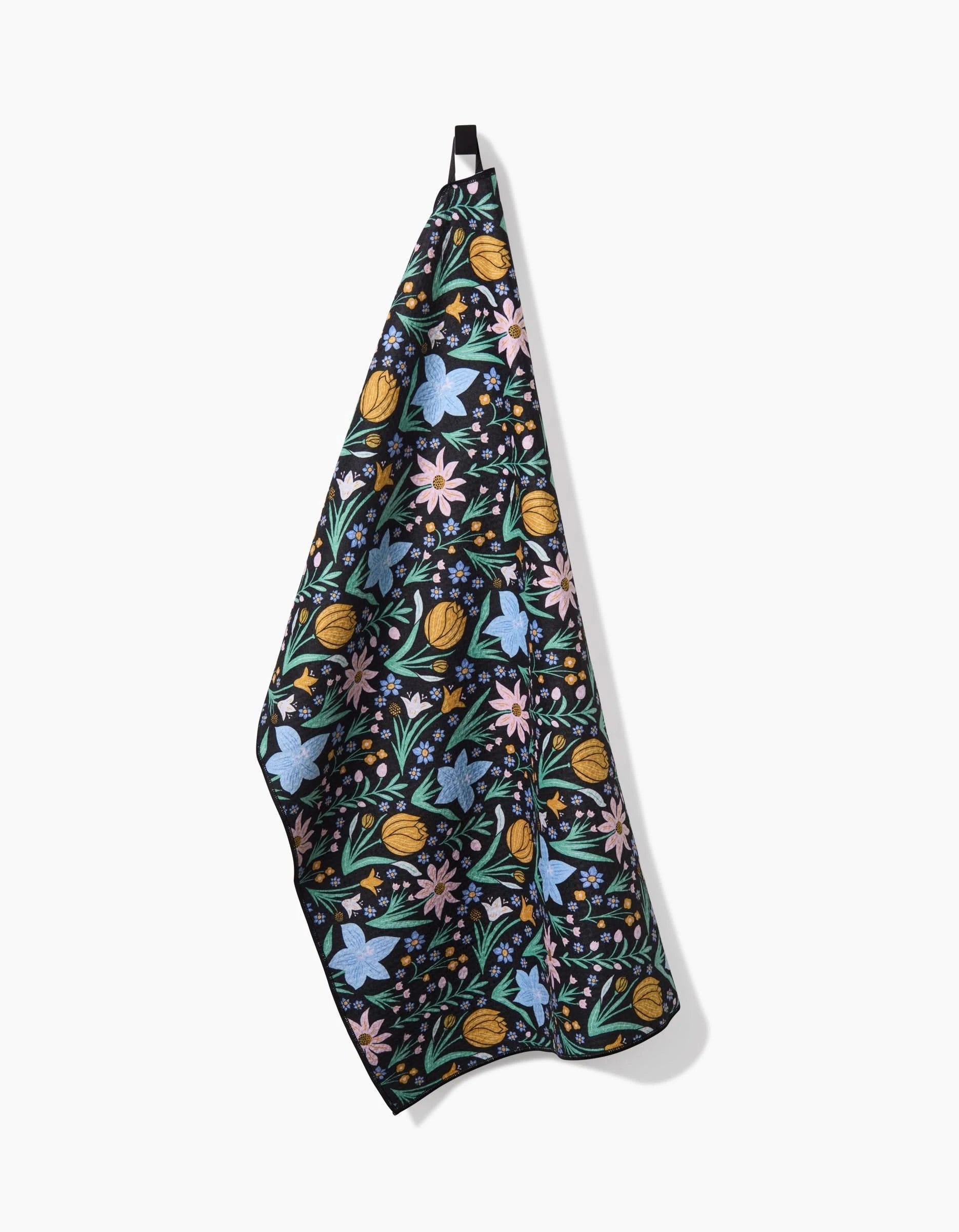 The Danelys Sidron Garden of Light hanging tea towel features a black background with vibrant blue, yellow, pink, and green floral patterns, and is thoughtfully crafted from post-consumer recycled materials.
