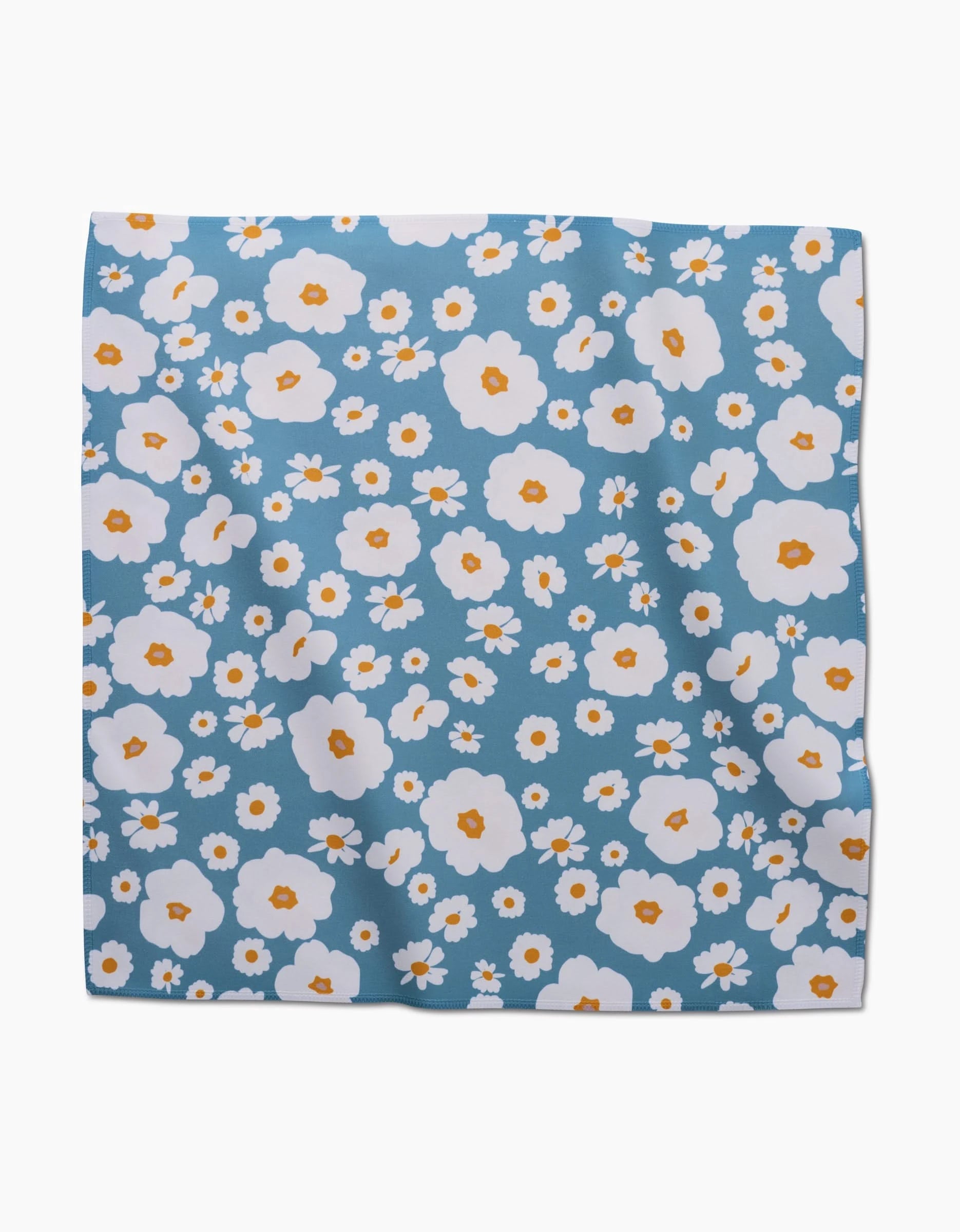 The GEOMETRY Happy Daysies is a square blue dinner napkin set made from soft Geosuede fabric, featuring a pattern of white and yellow flowers.