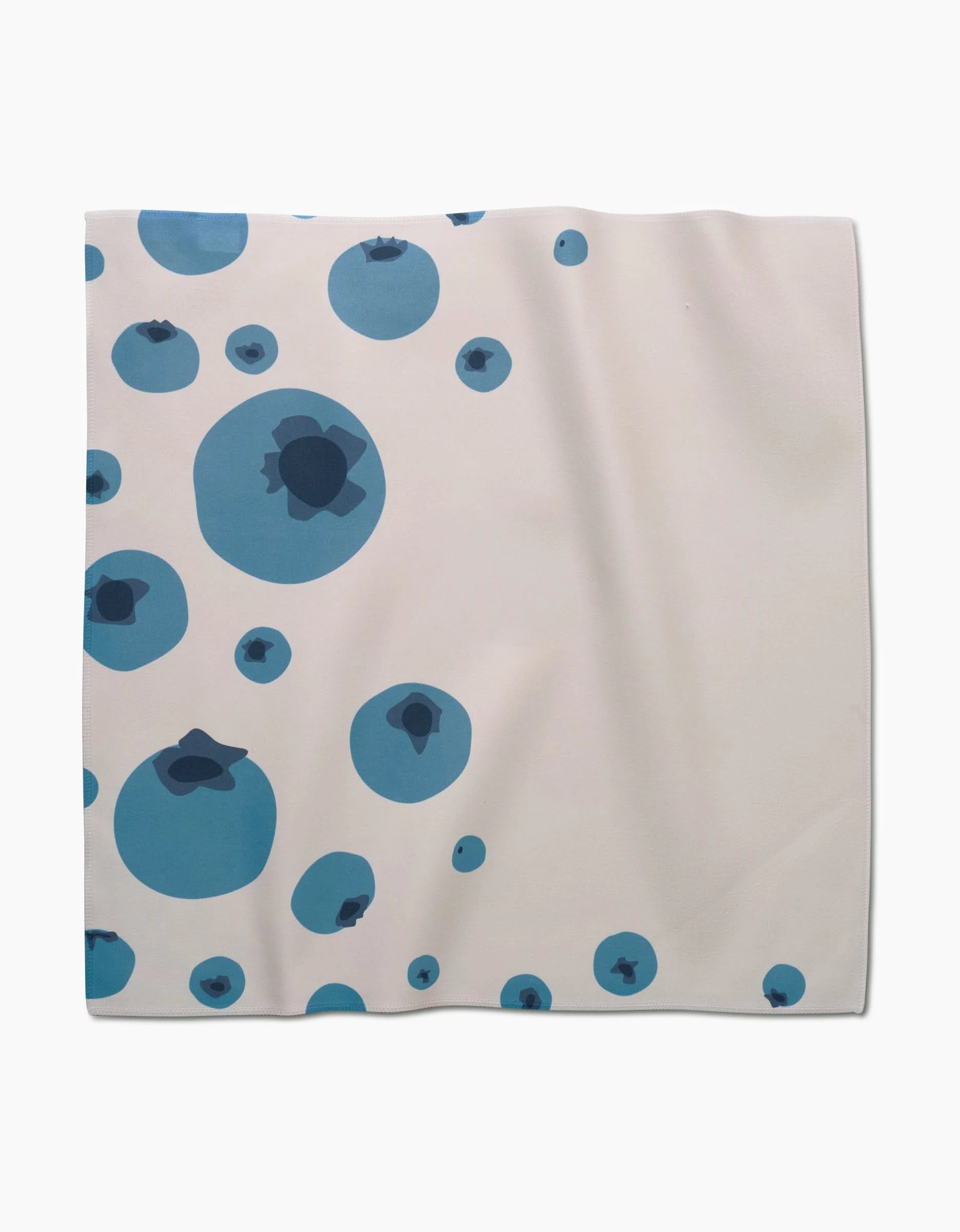 The GEOMETRY Sunny Fruit dinner napkin is made of white Geosuede fabric and features various-sized blue circles with darker blue abstract shapes inside, scattered mainly on the left side.