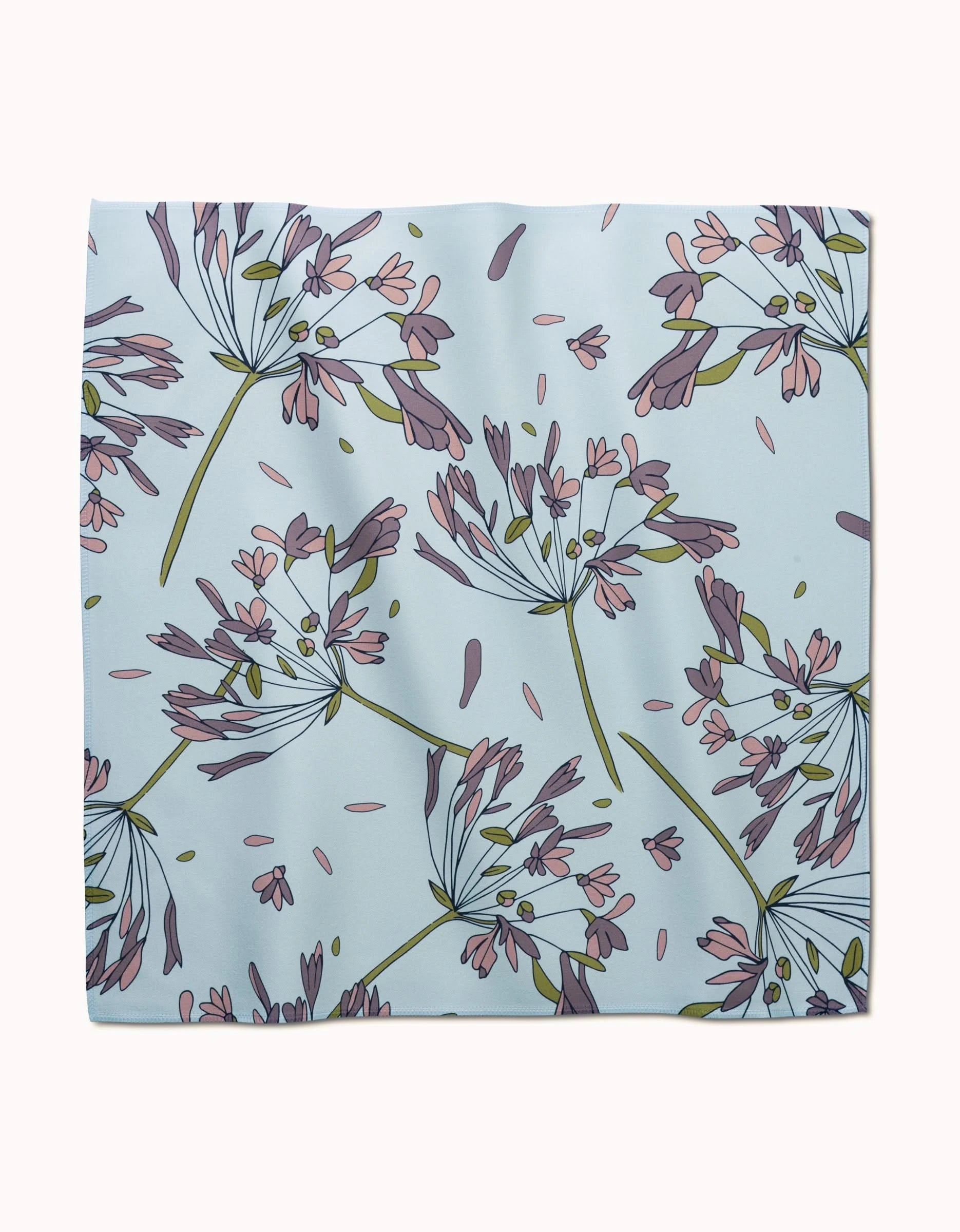The Wind by GEOMETRY is a square, light blue reusable dinner napkin with a floral design of purple and pink flowers with green stems and leaves in various directions.
