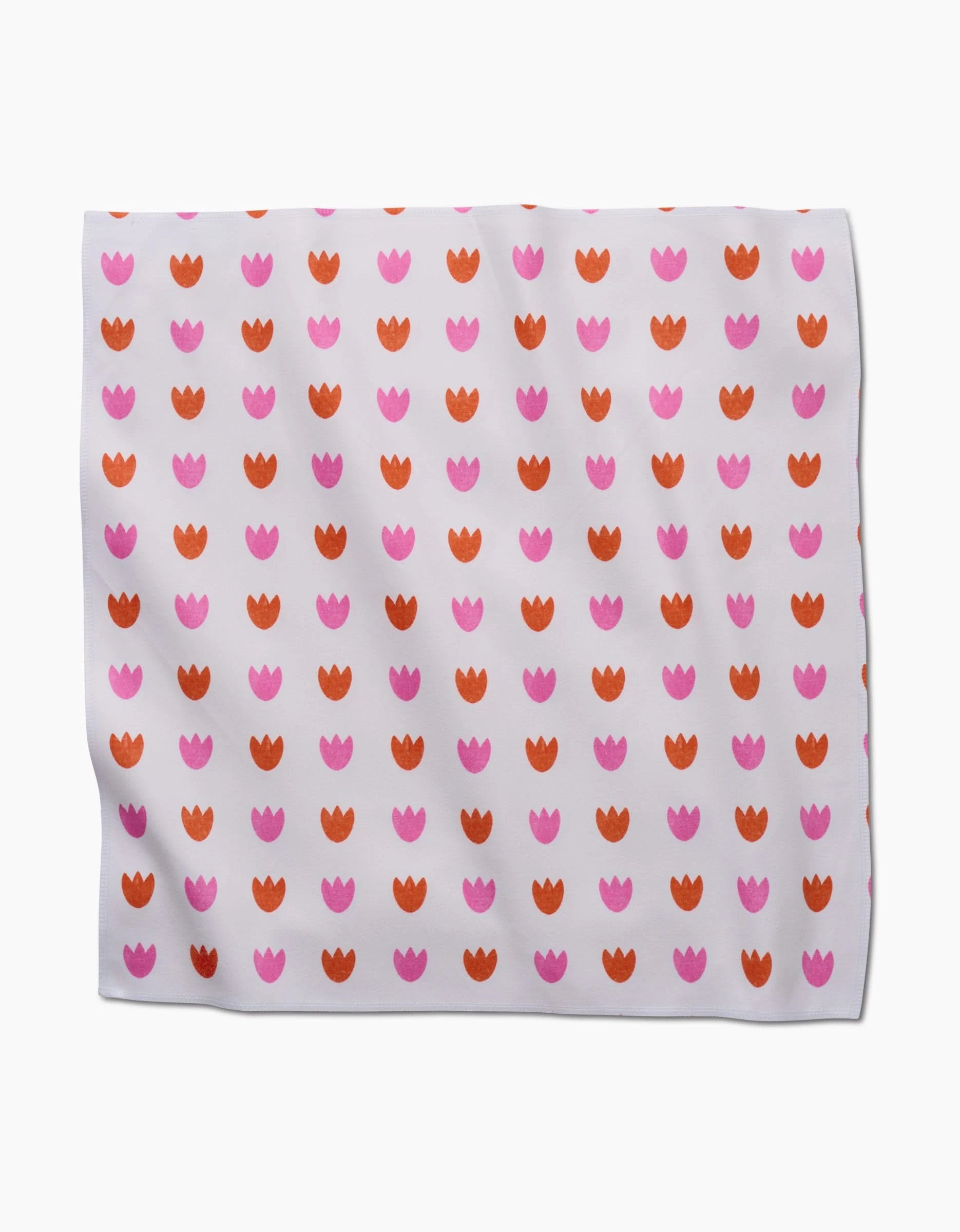 The Addison fabric by Amy MacCready is a white Geosuede cloth made from recycled materials, featuring a grid of small pink and orange tulip shapes in alternating rows. The fabric has a slightly wrinkled appearance.