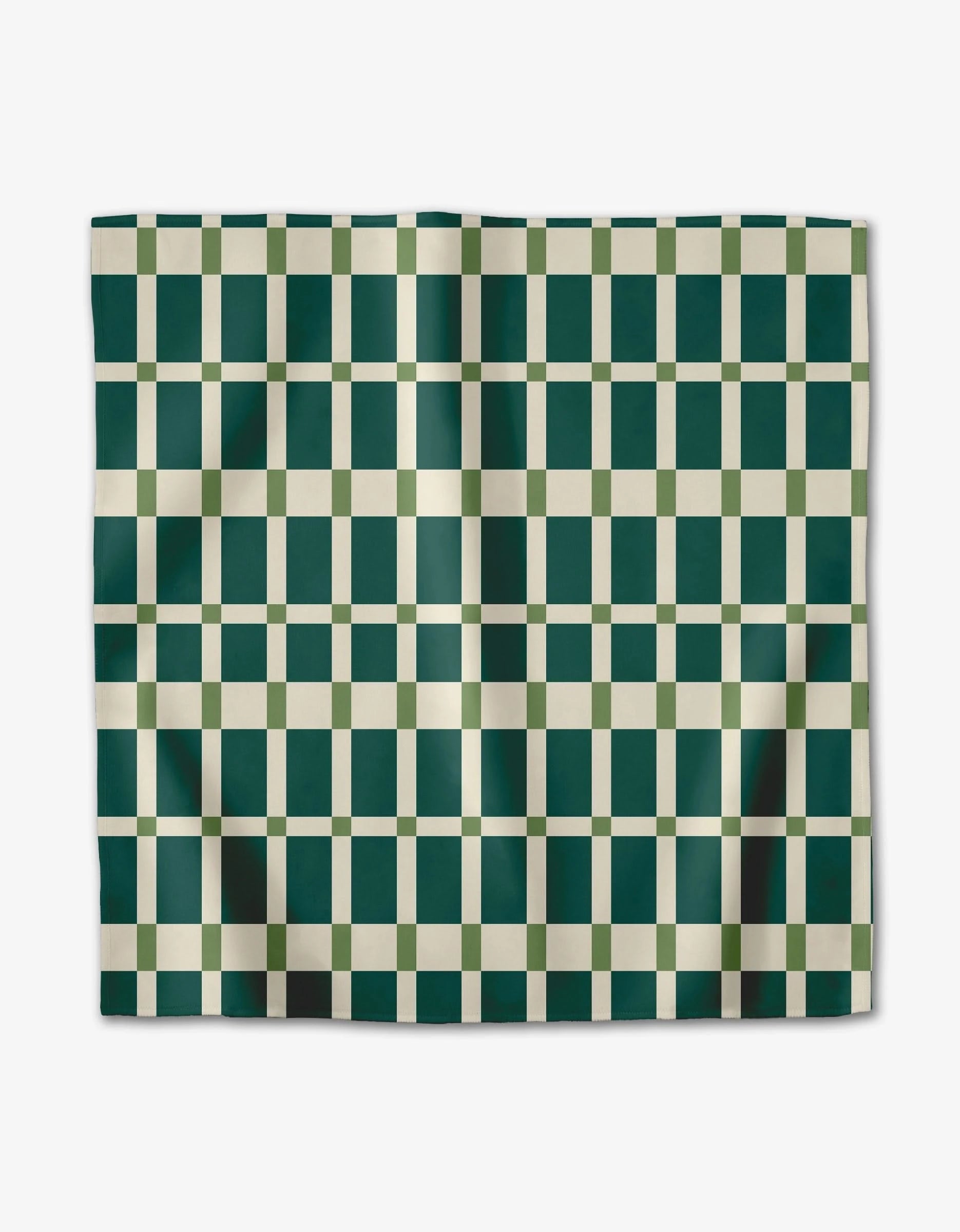 The Rebecca Woolbright Candy Plaid set features rectangular Geosuede dinner napkins with a checkered pattern of dark green and cream squares, subtly folded and shown against a plain white background.