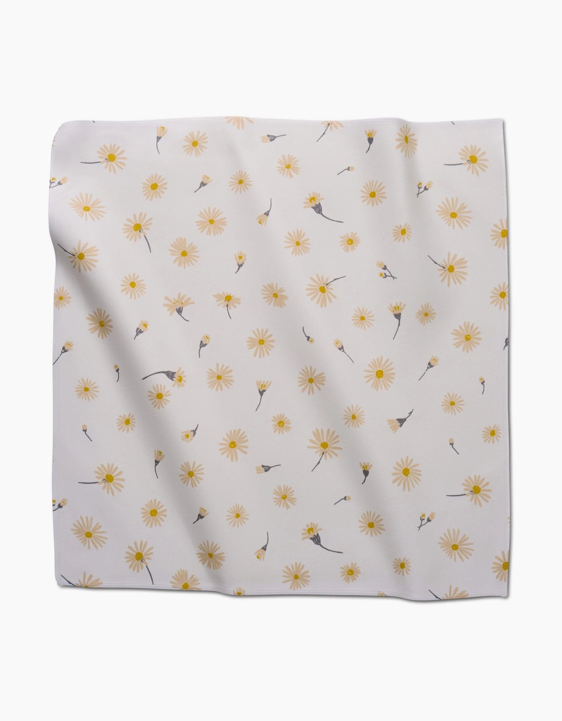 The Daisy Dust dinner napkin by Hufton Studio is a square, light Geosuede fabric featuring yellow daisies and gray flowers. Made from recycled materials, this slightly wrinkled napkin lays flat against a white background.
