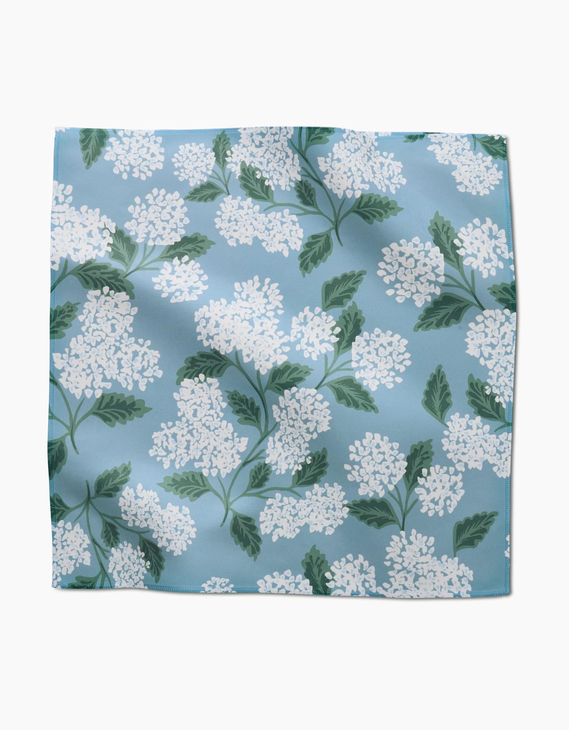 The Garden Of Edith by GEOMETRY is a square Geosuede scarf featuring white lilac flowers and green leaves on a light blue background.