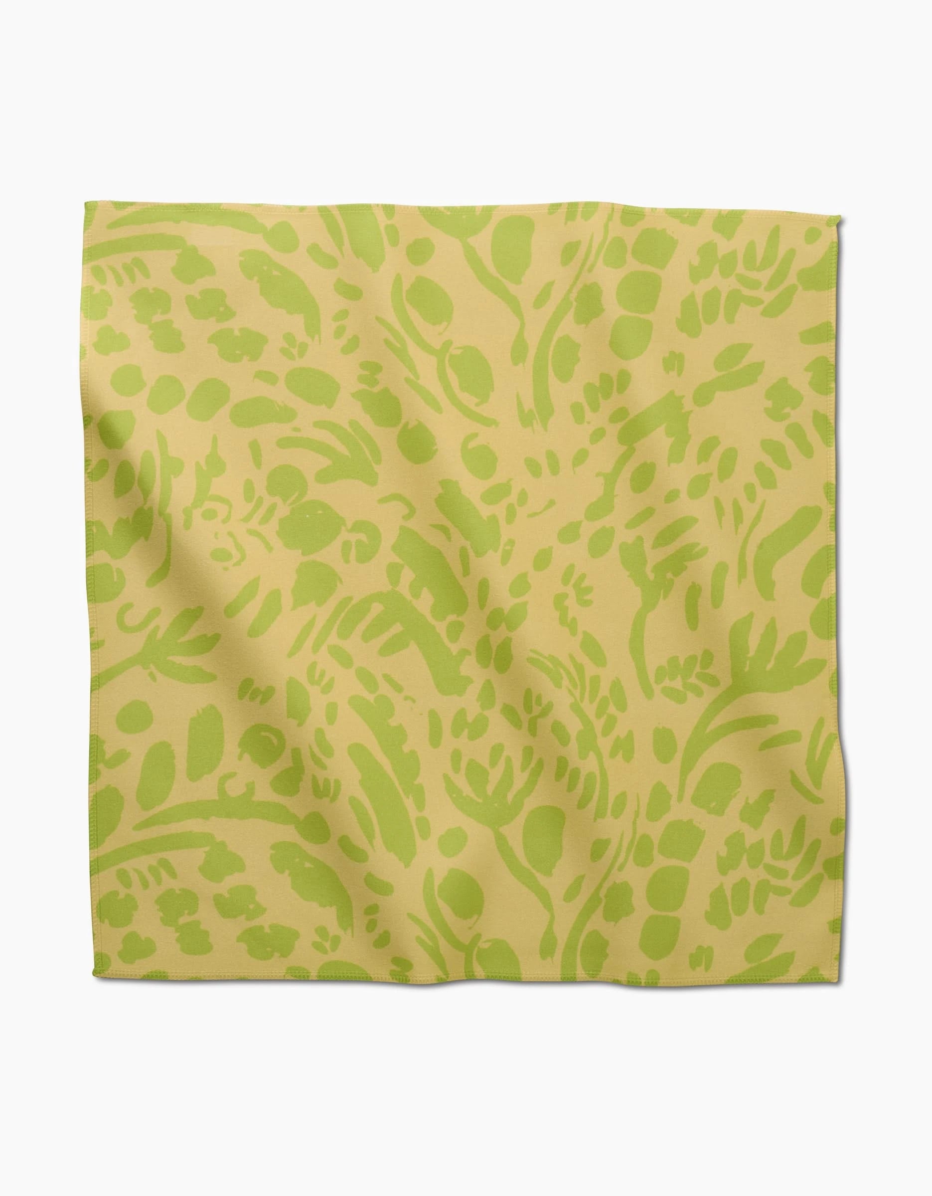 The Sareka Unique Green Spring napkin is a square Geosuede dinner napkin with a yellow background and light green abstract botanical leaf and branch patterns.