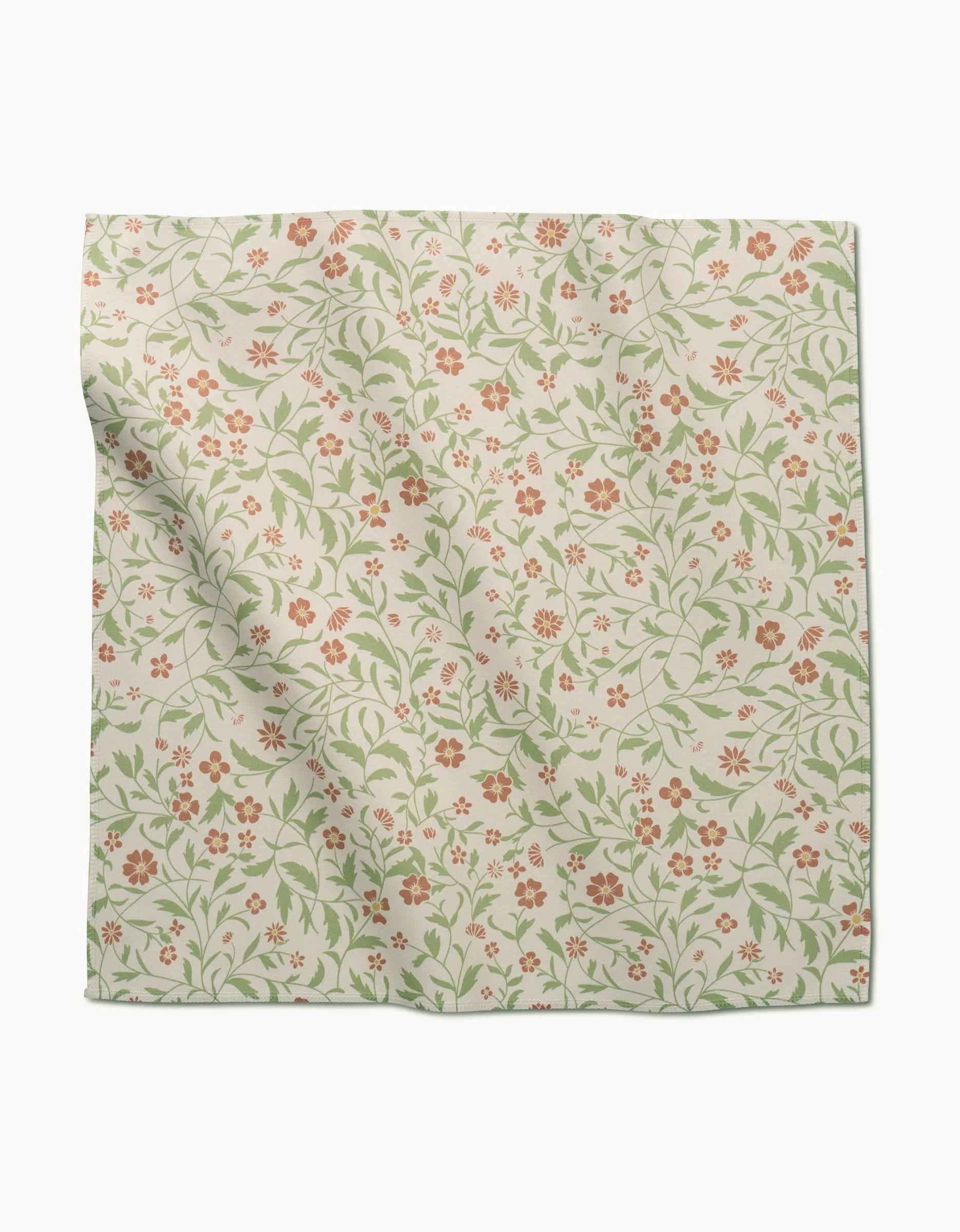 A square piece of Geosuede fabric by Danelys Sidron, called Hawthorns, with a light beige background and a repeating floral pattern in red, pink, and green—perfect for Dinner Napkins and featuring gentle folds and creases.