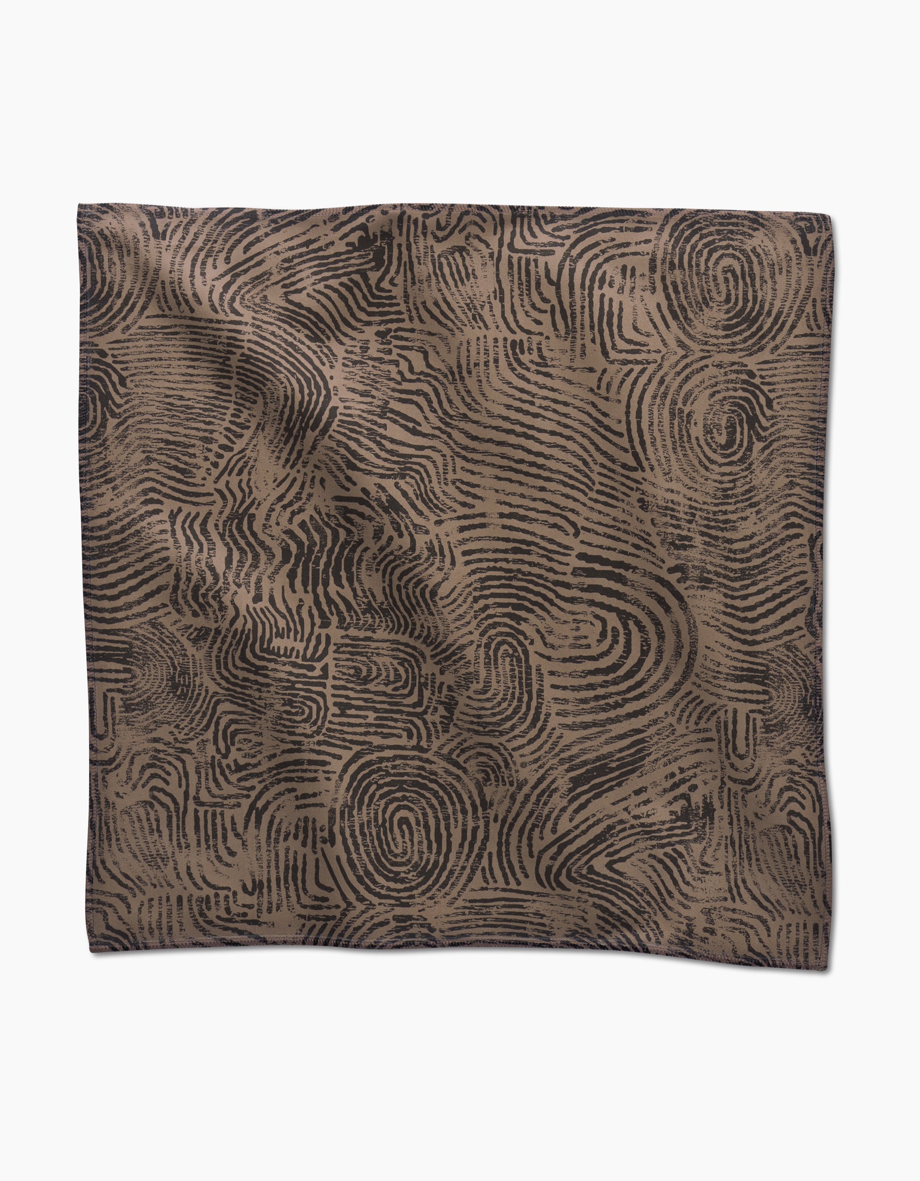 Studio Jeannot’s Imprint is a square dinner napkin set made from recycled Geosuede, featuring a brown base with abstract black fingerprint-like swirls, shown flat on a white background.