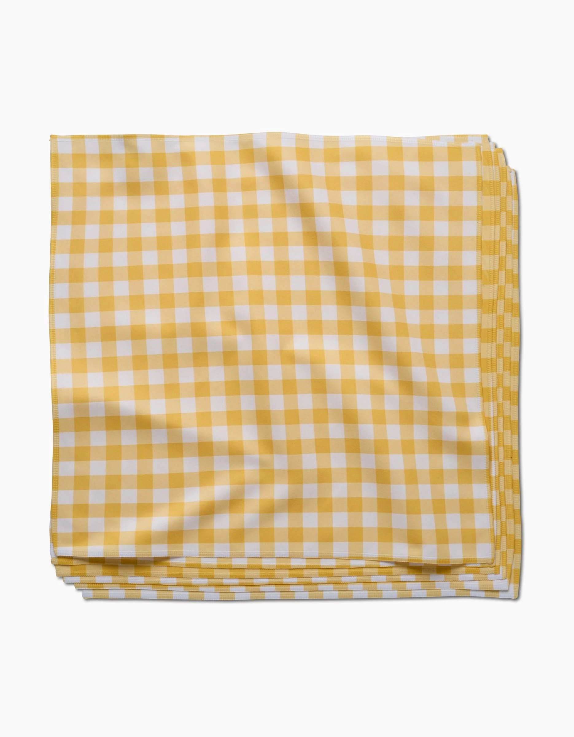 The GEOMETRY Lemon Gingham napkin, crafted from Geosuede fabric in a yellow and white checkered pattern, is neatly folded on a white background.