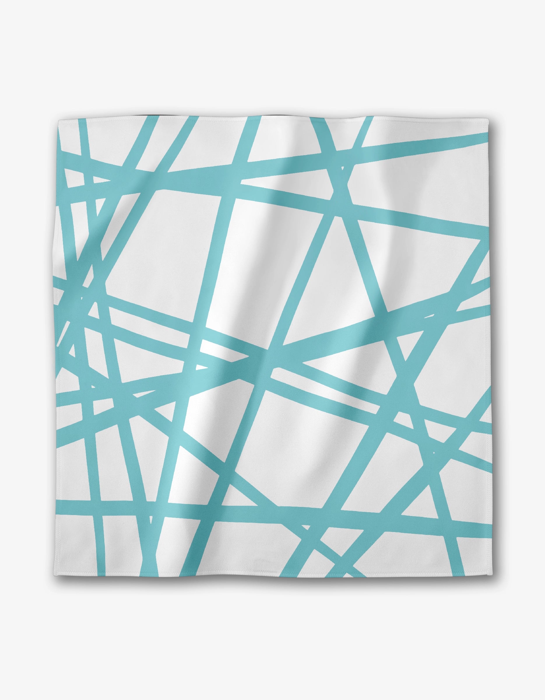The Playful Blues dinner napkin by GEOMETRY features white Geosuede fabric with an abstract pattern of intersecting turquoise blue lines forming geometric shapes. The eco-friendly material has a slightly wrinkled look.