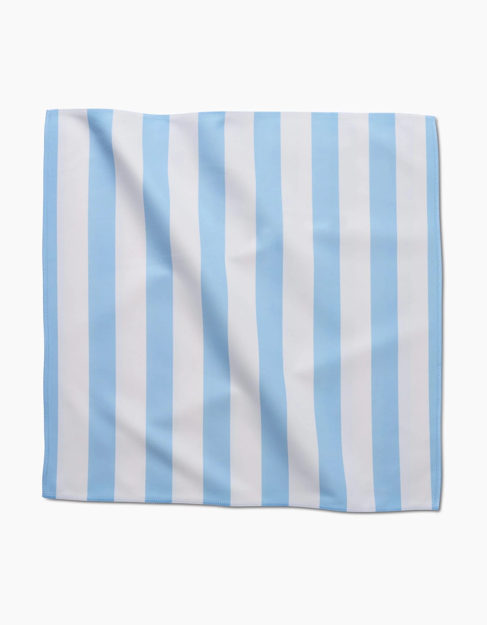 The GEOMETRY Seaside Stripes dinner napkin, made from soft Geosuede fabric and featuring vertical light blue and white stripes, is displayed flat on a white background.